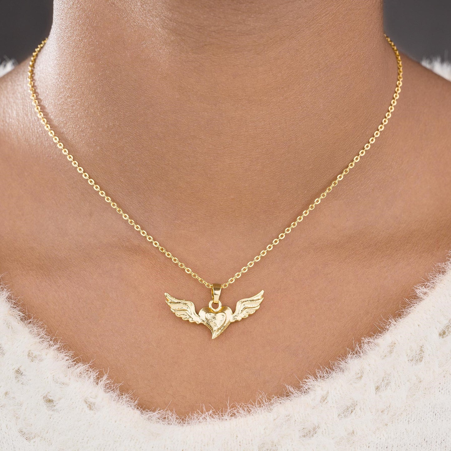 golden necklace with a bird on it