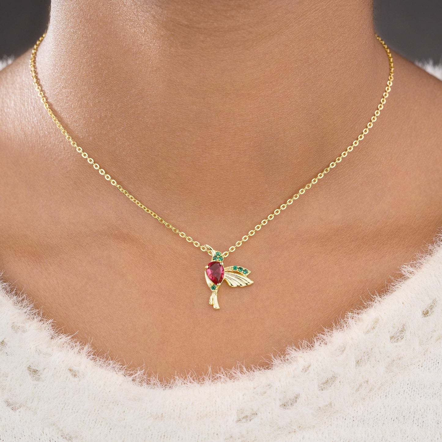 golden necklace with a bird pendant