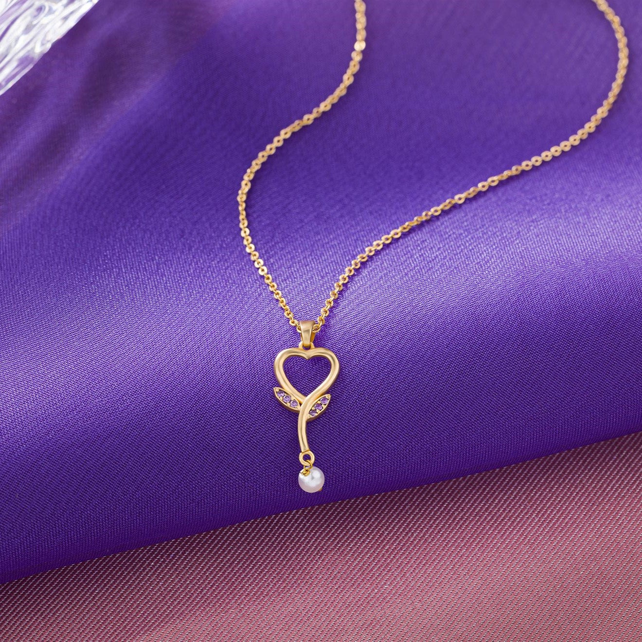 golden necklace with a diamond heart pendant