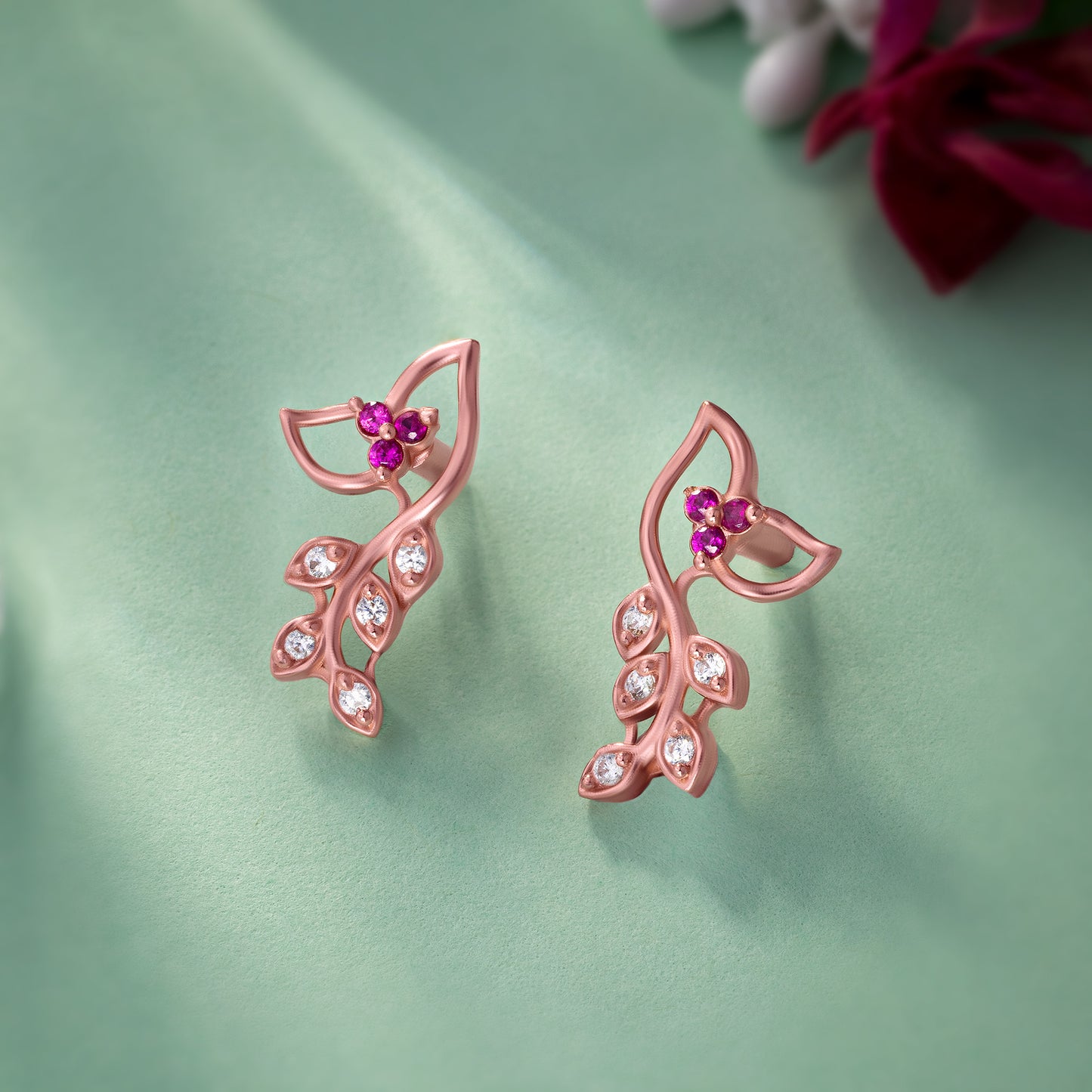 pair of rose gold earrings with diamonds