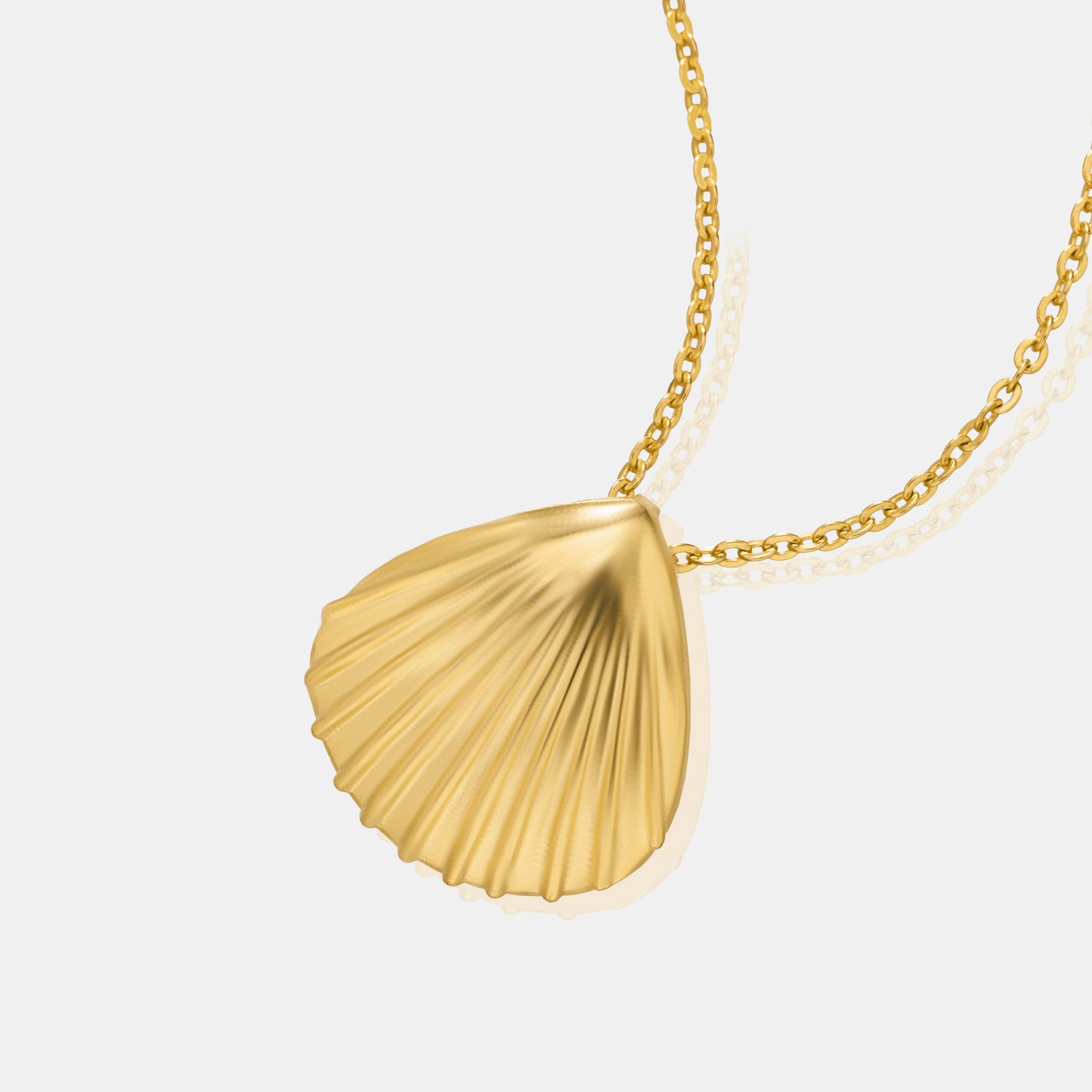 golden necklace with a shell on it