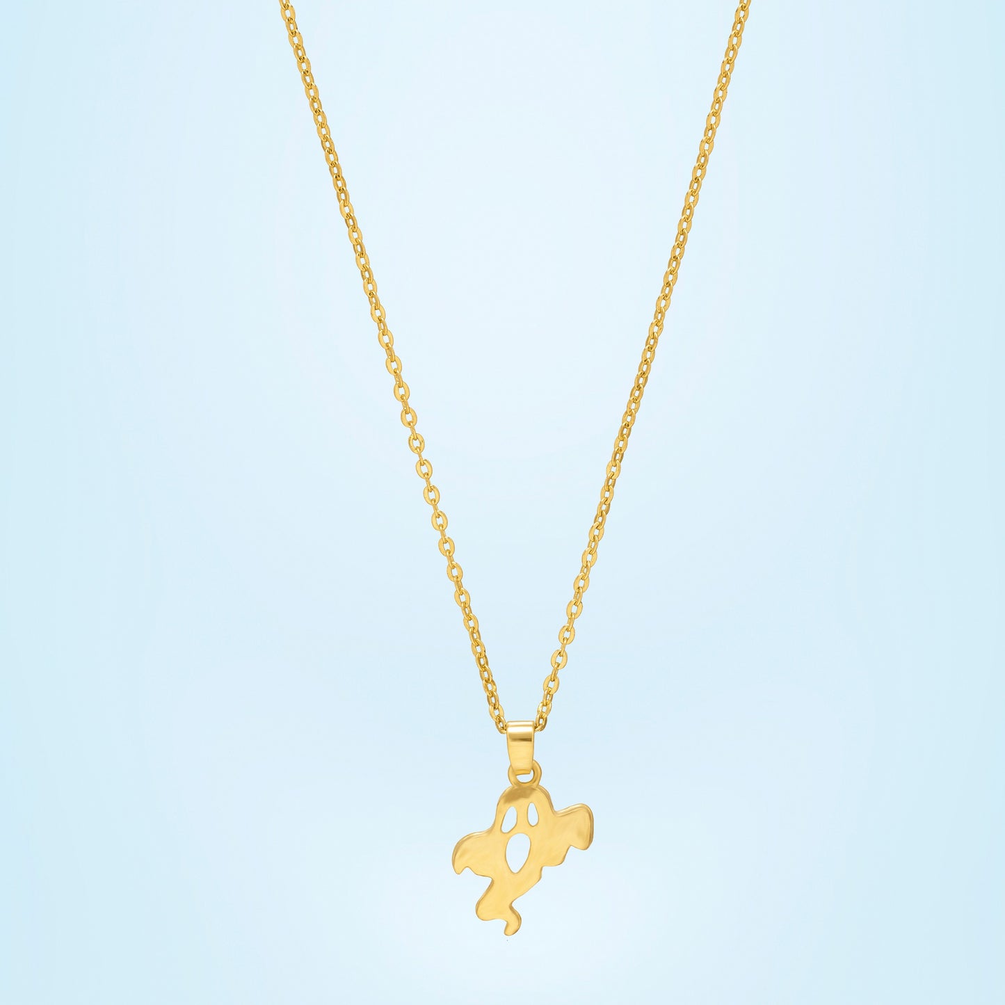 golden necklace with a small ghost  on it