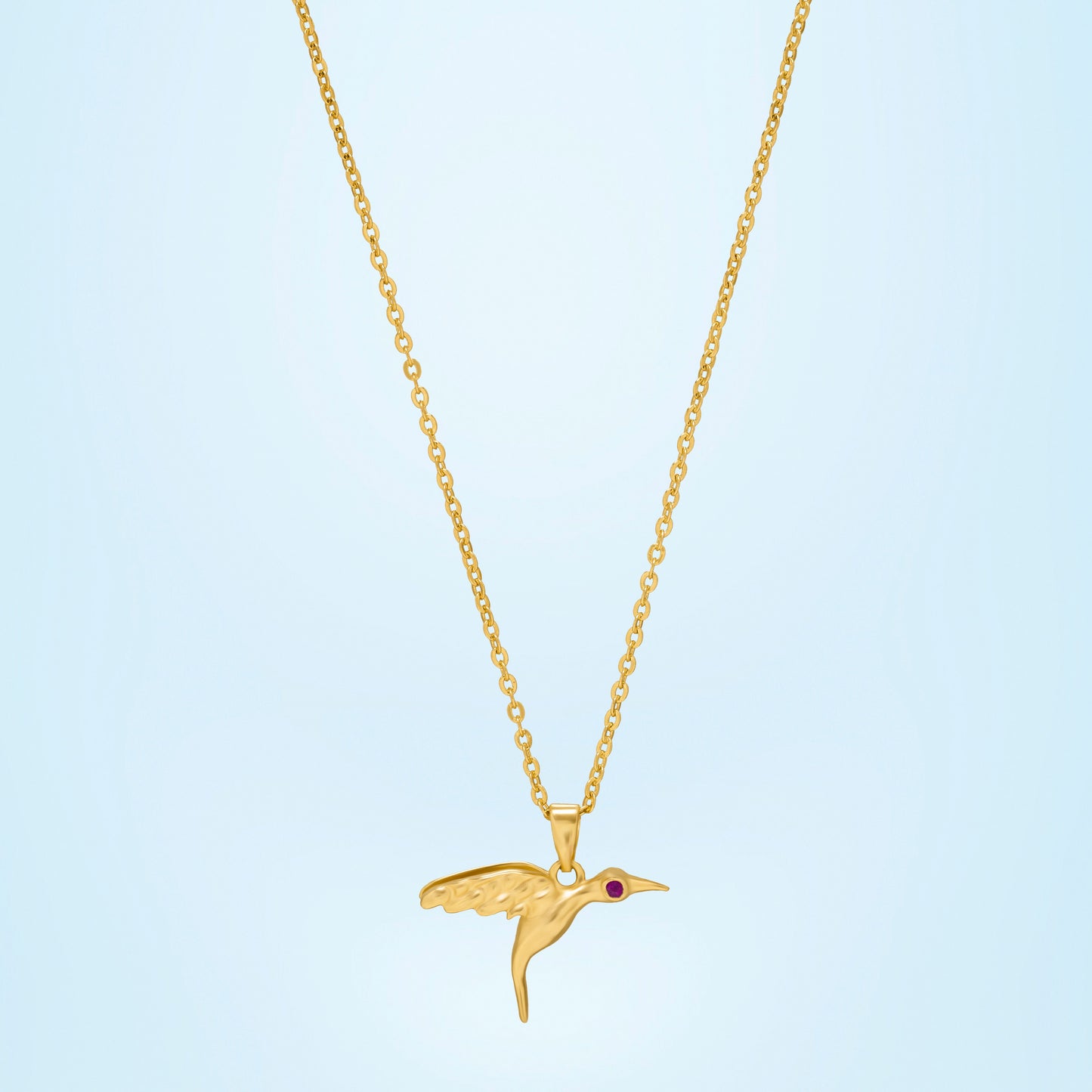 golden bird necklace with a diamond on the front