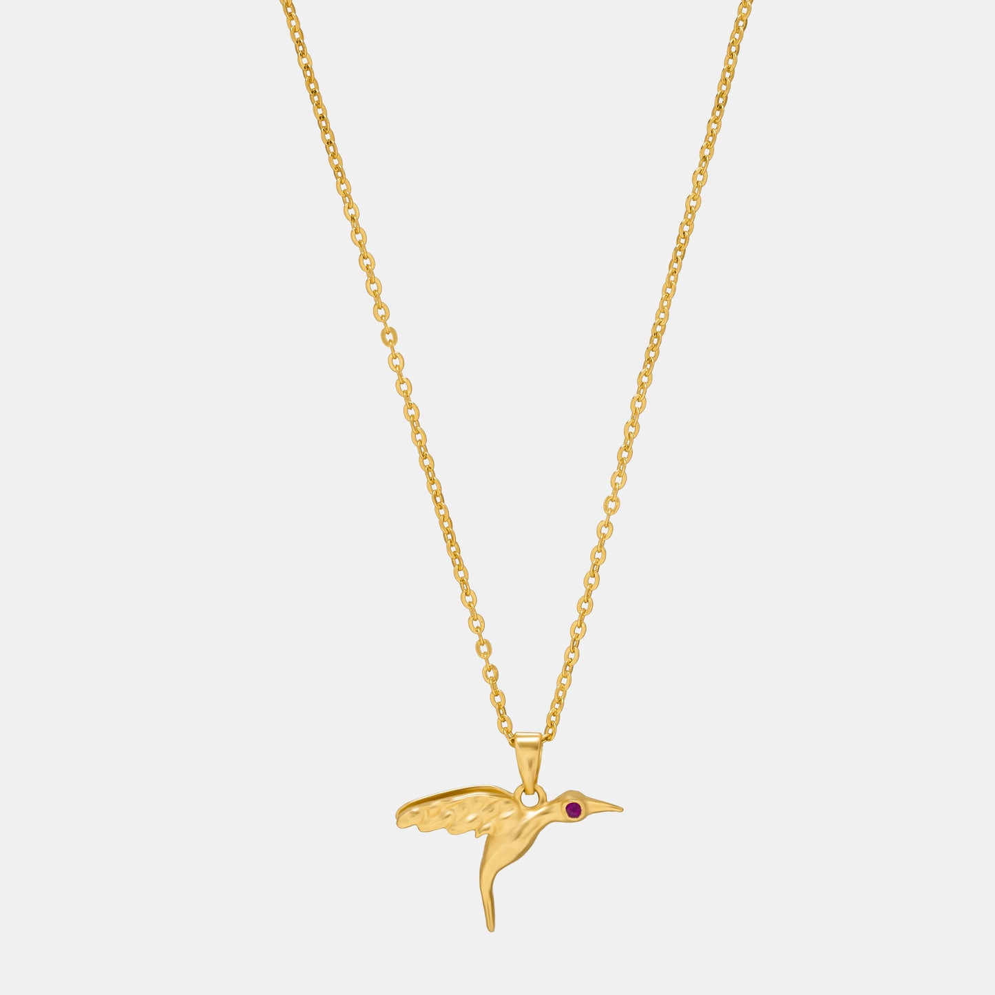 golden bird necklace with a diamond on the front