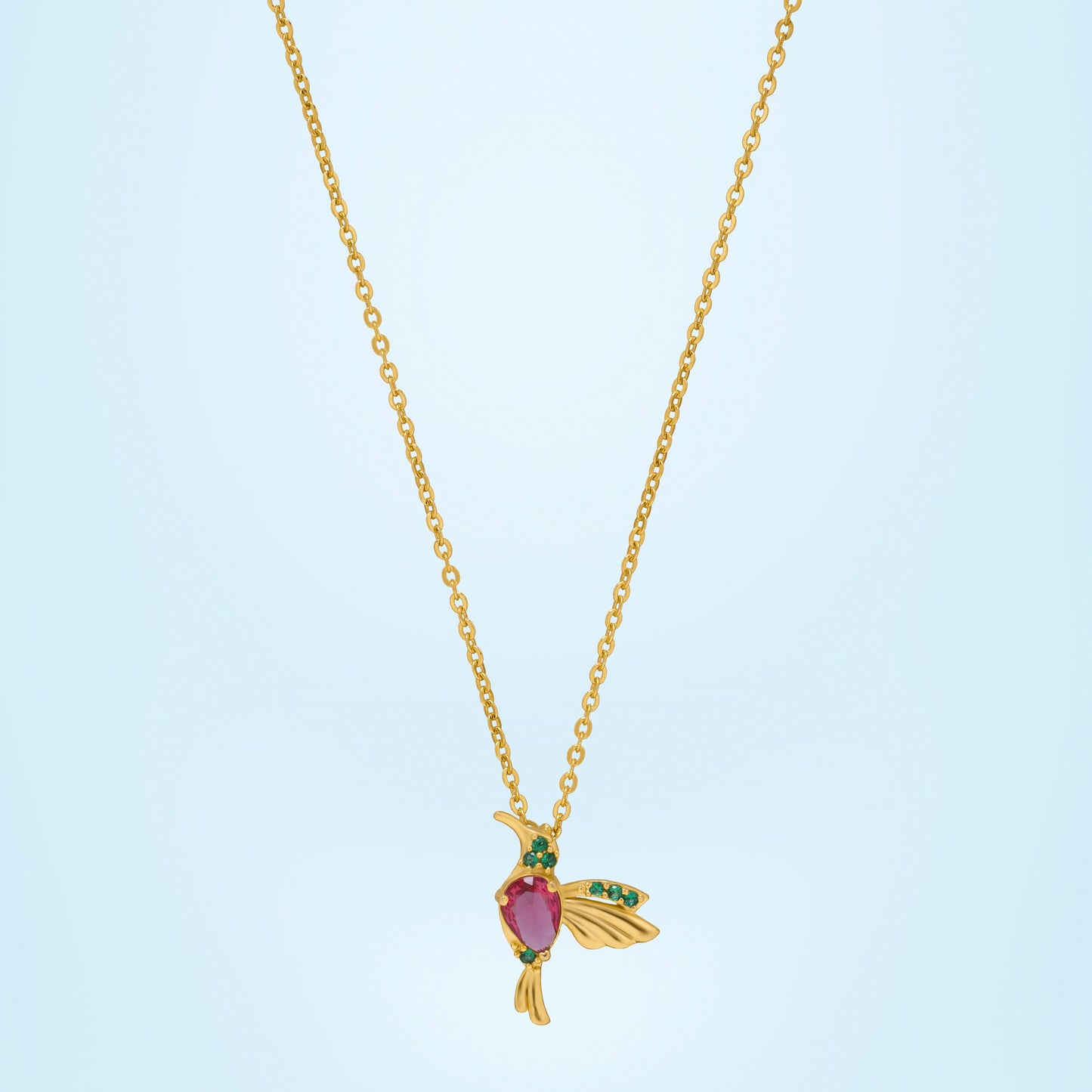 golden necklace with a bird pendant