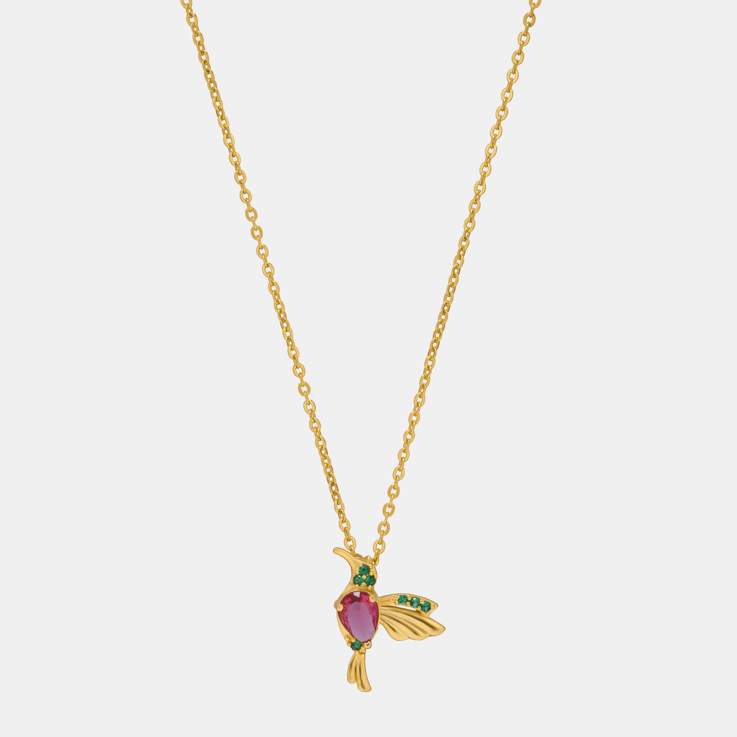 golden necklace with a bird pendant