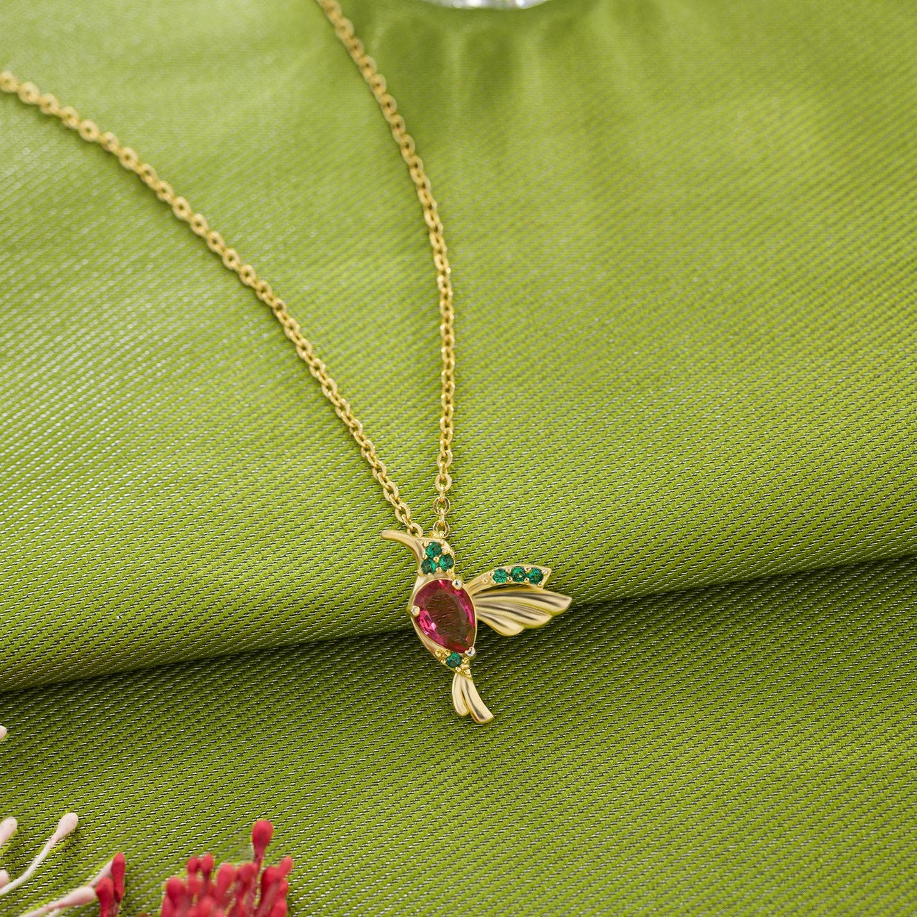 golden necklace with a bird pendant