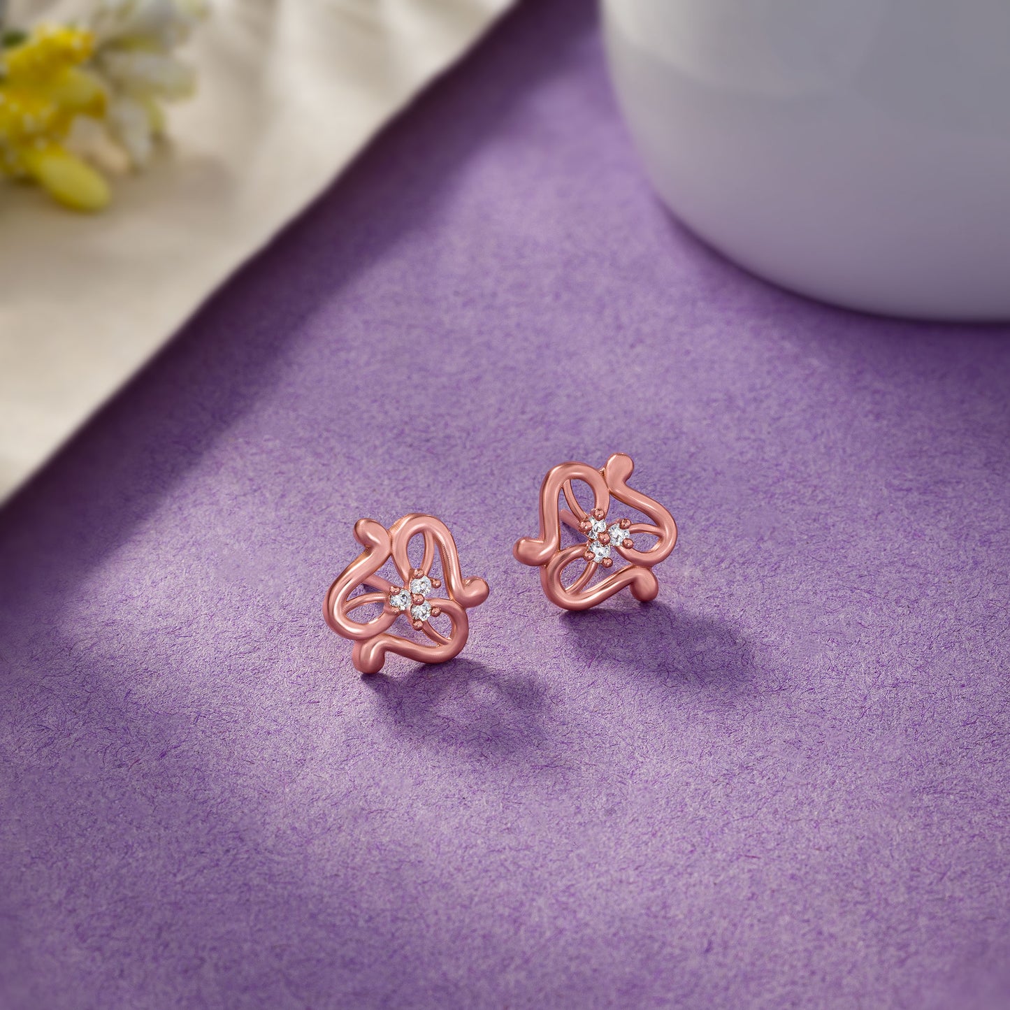 pair of rose gold earrings with white stones