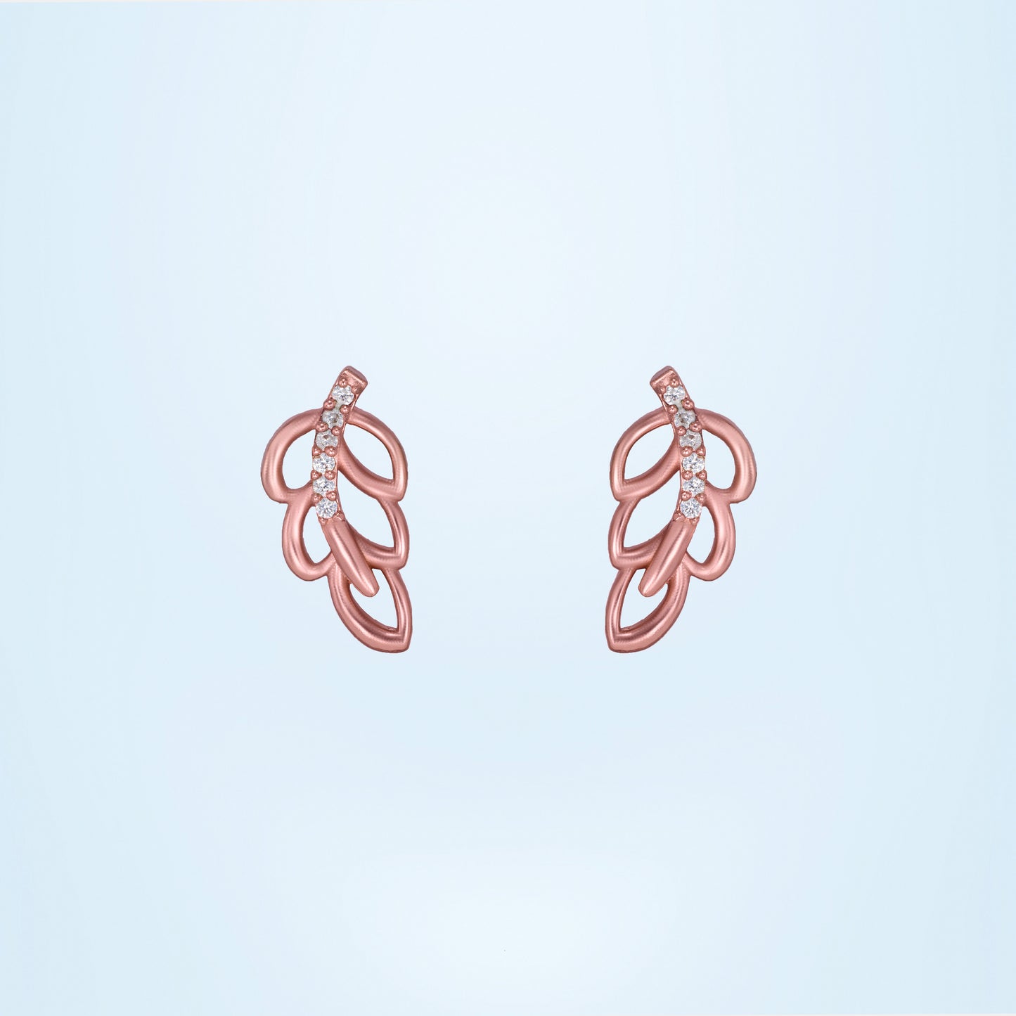 pair of rose gold earrings with a single diamond