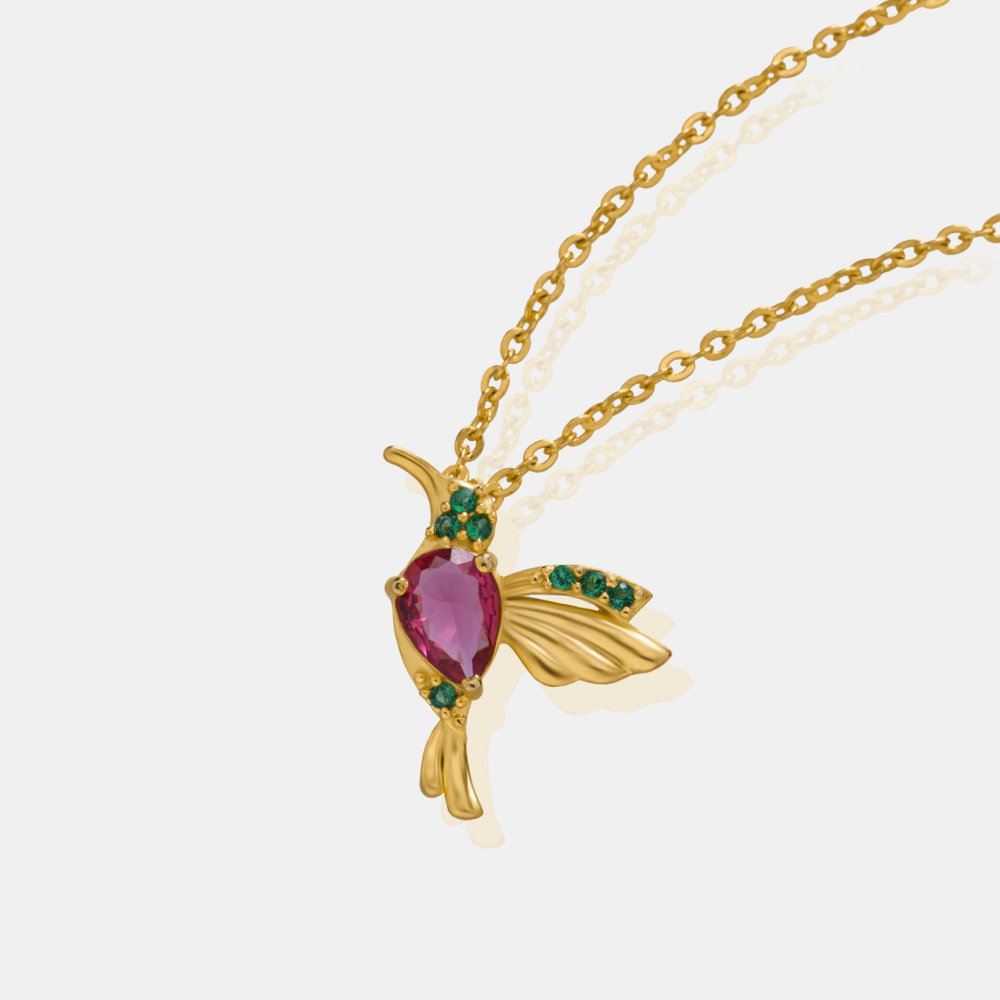 golden necklace with a bird pendant