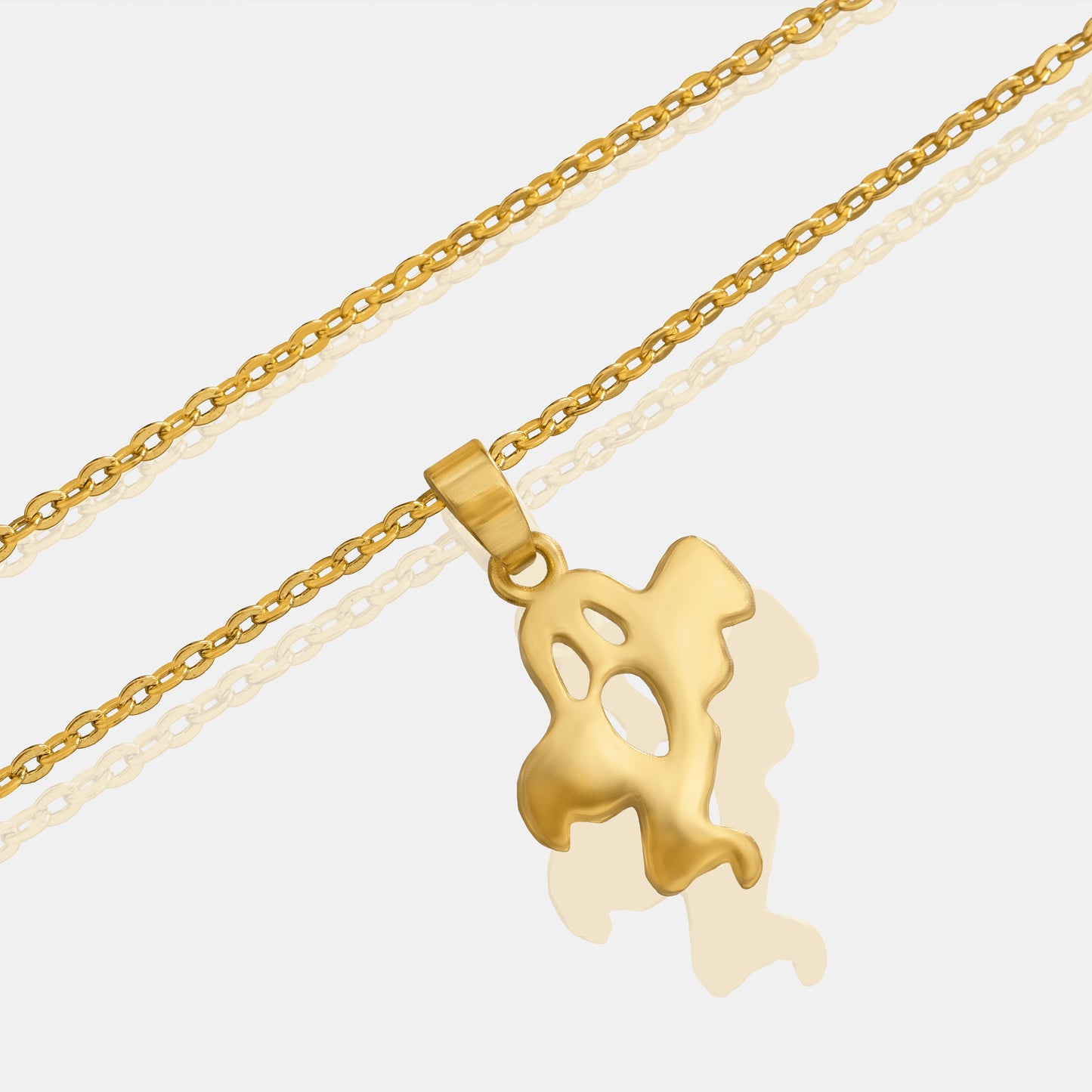 golden necklace with a small ghost  on it