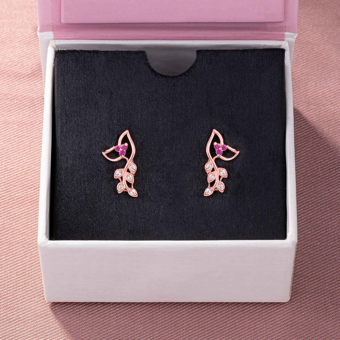 pair of rose gold earrings with diamonds