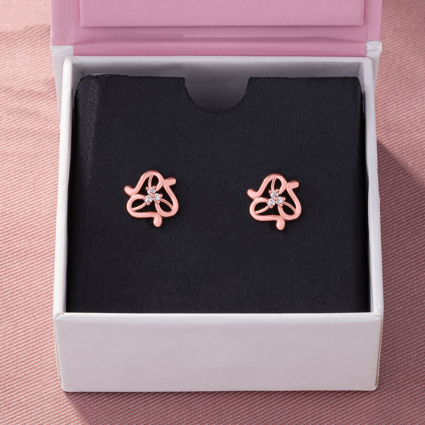 pair of rose gold earrings with white stones