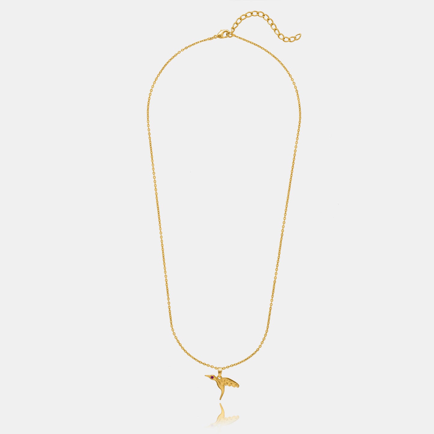 golden bird necklace with a diamond on the front