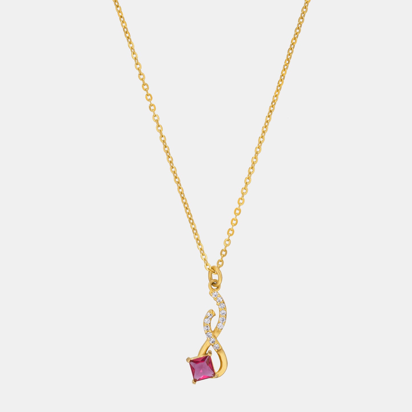 golden necklace with a red stone pendant