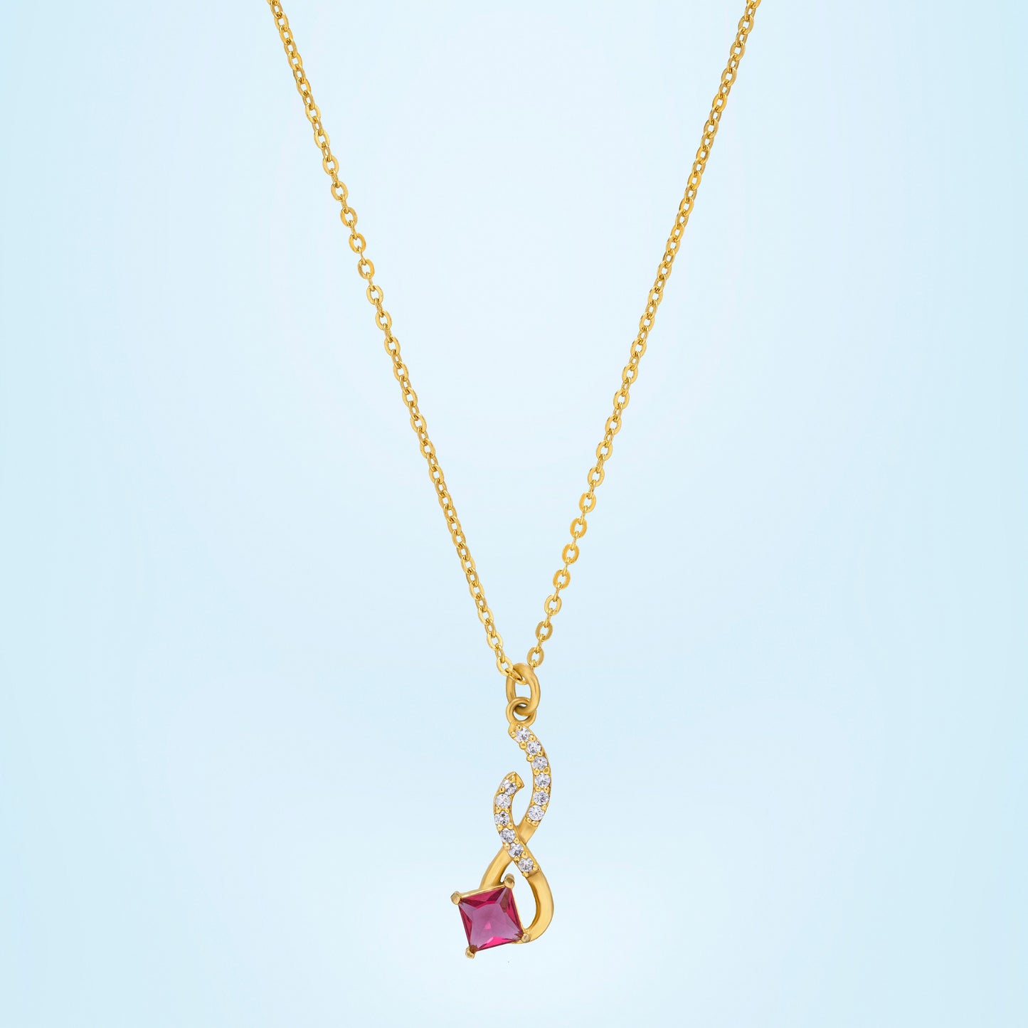 golden necklace with a red stone pendant