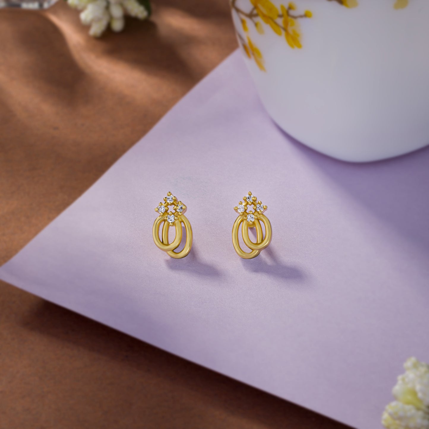 pair of golden earrings with a diamond