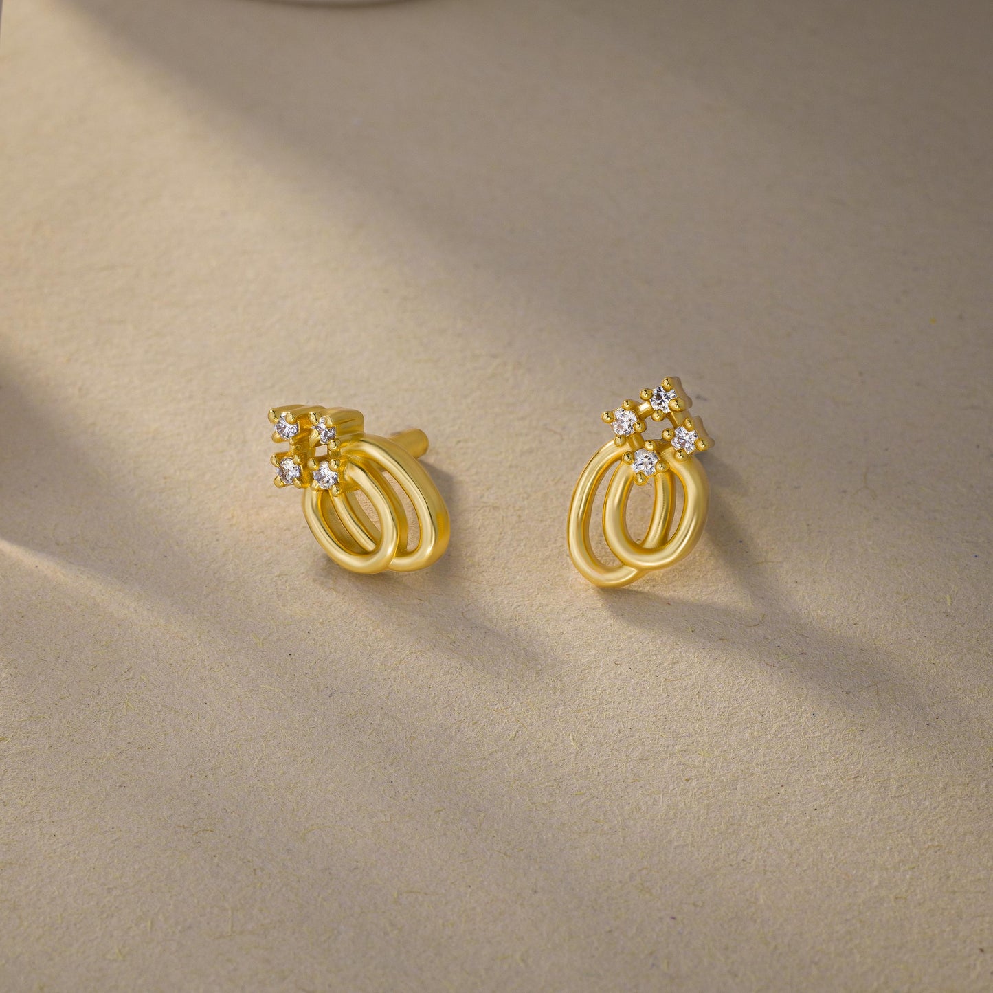 pair of golden earrings with a diamond