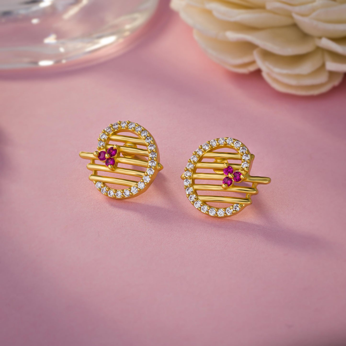 pair of golden earrings with ruby and diamonds