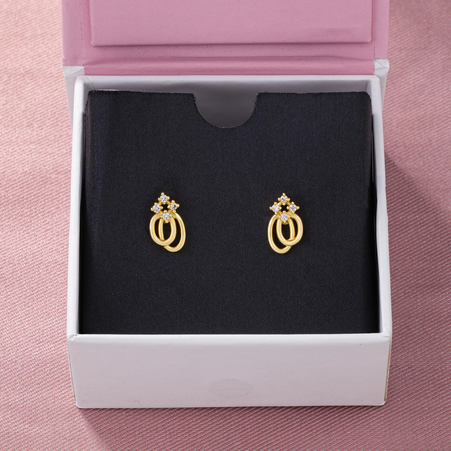 pair of golden earrings with a diamond