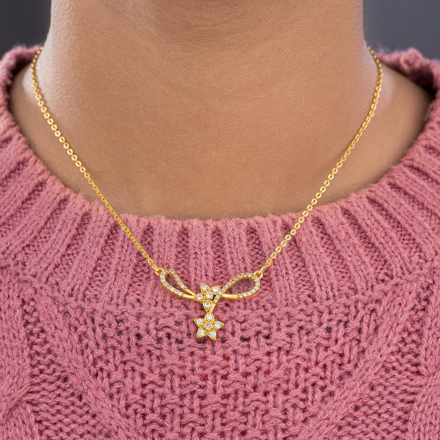 golden necklace with a diamond star on it