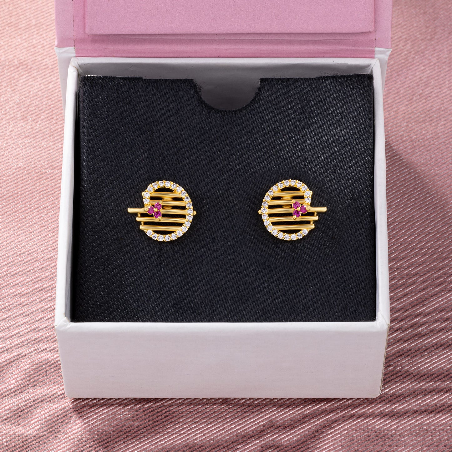 pair of golden earrings with ruby and diamonds