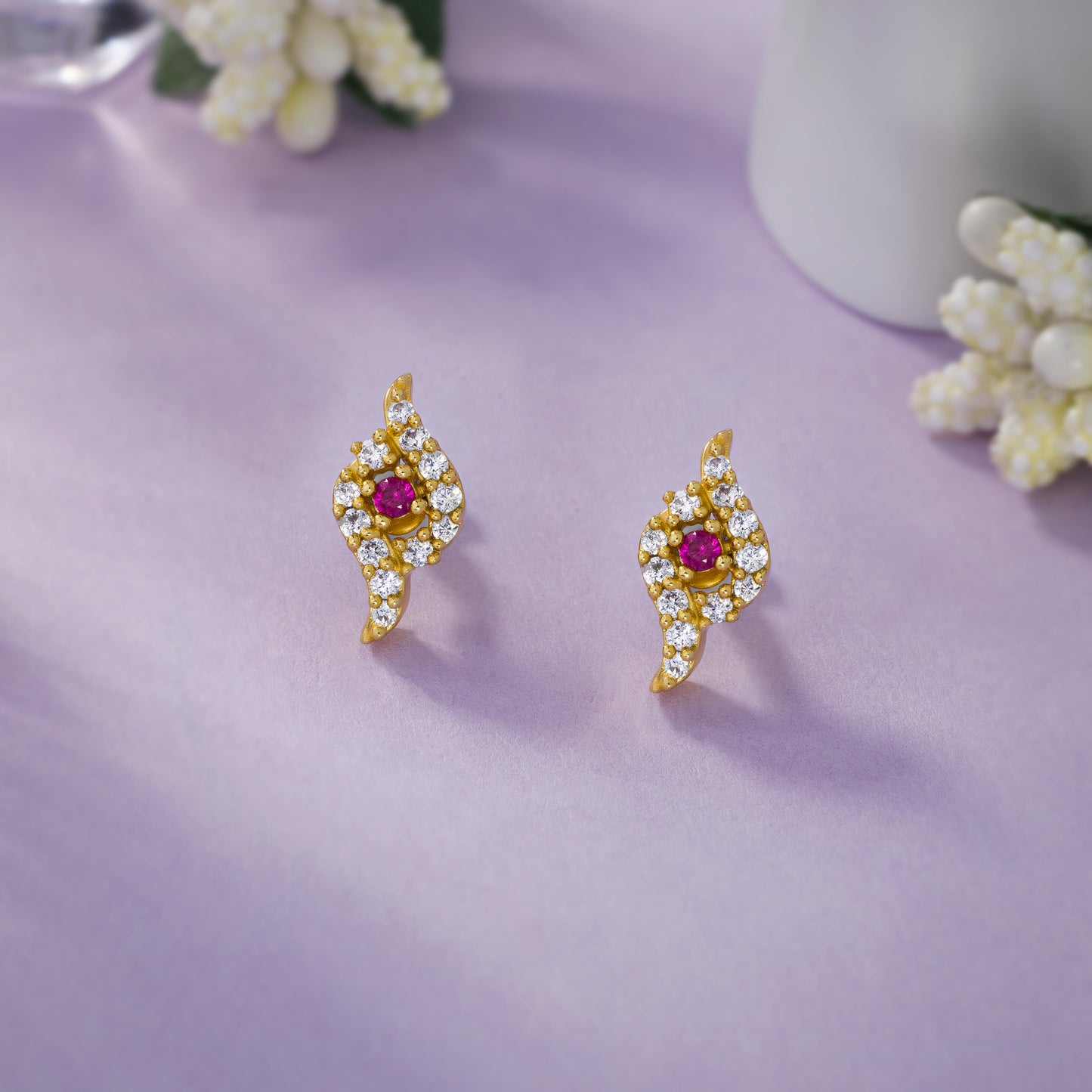 pair of golden earrings with ruby and diamonds