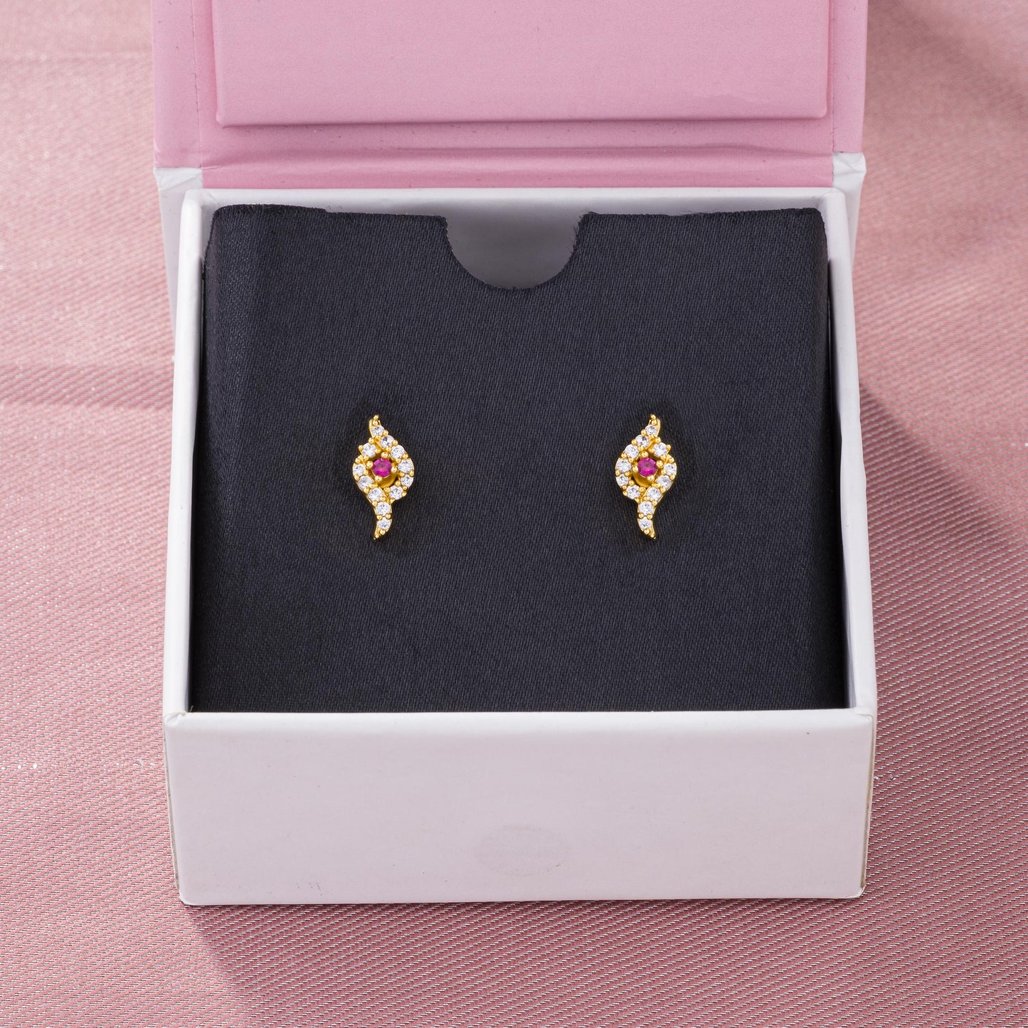 pair of golden earrings with ruby and diamonds