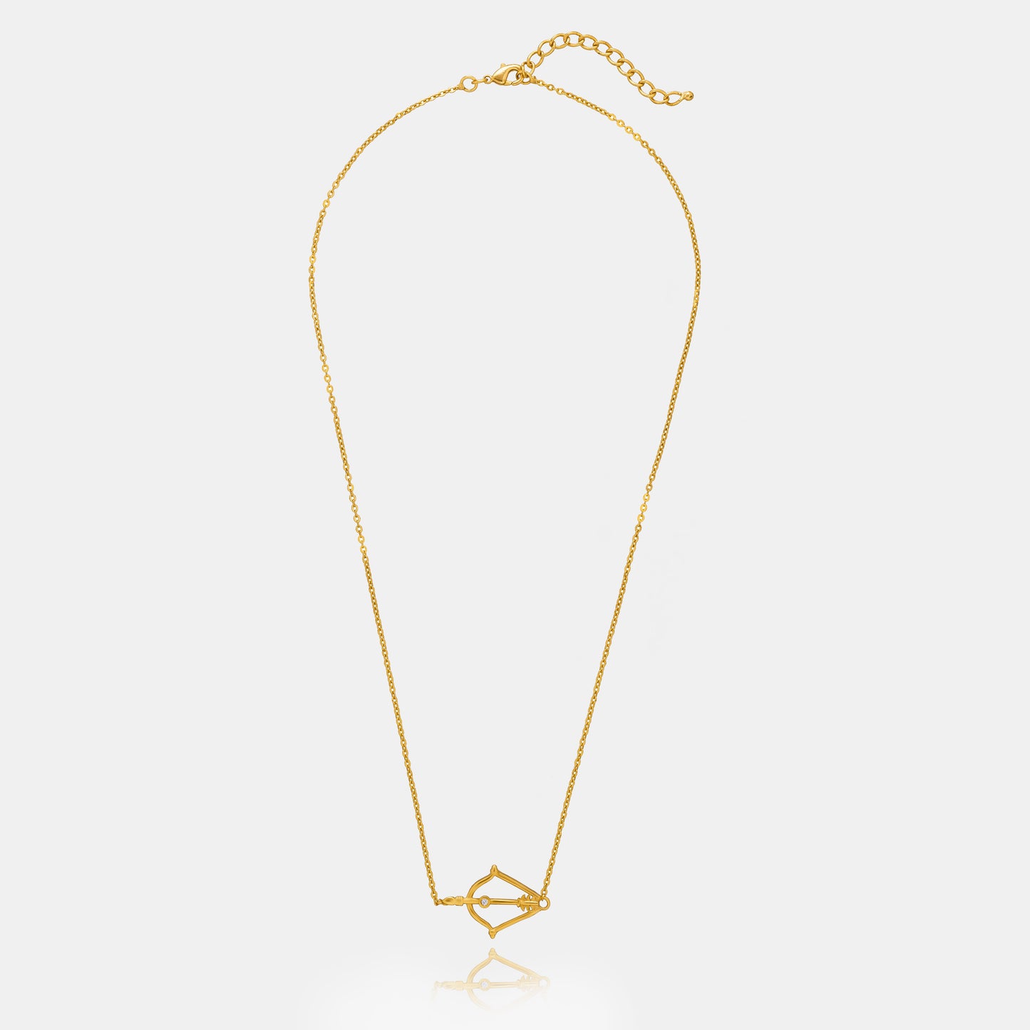 golden necklace with a small arrow on it