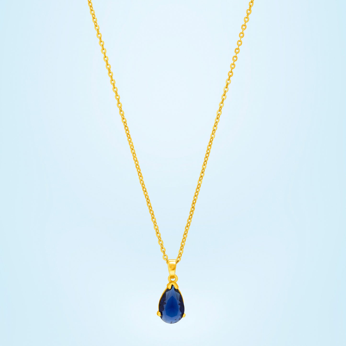 golden necklace with a small blue stone