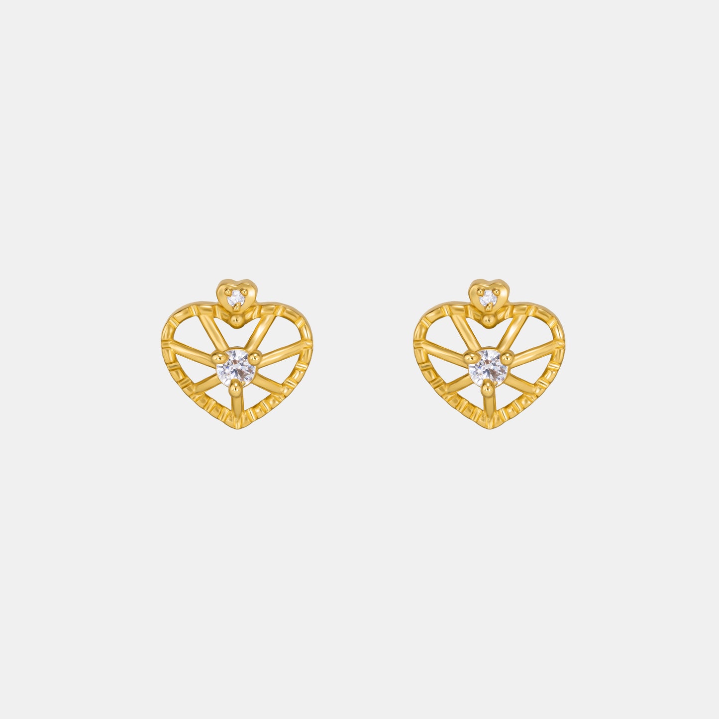 pair of golden earrings with a heart shaped diamond