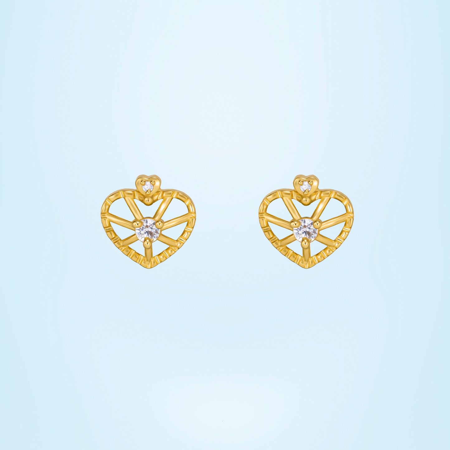 pair of golden earrings with a heart shaped diamond