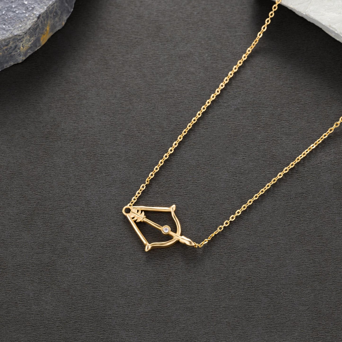 golden necklace with a small arrow on it