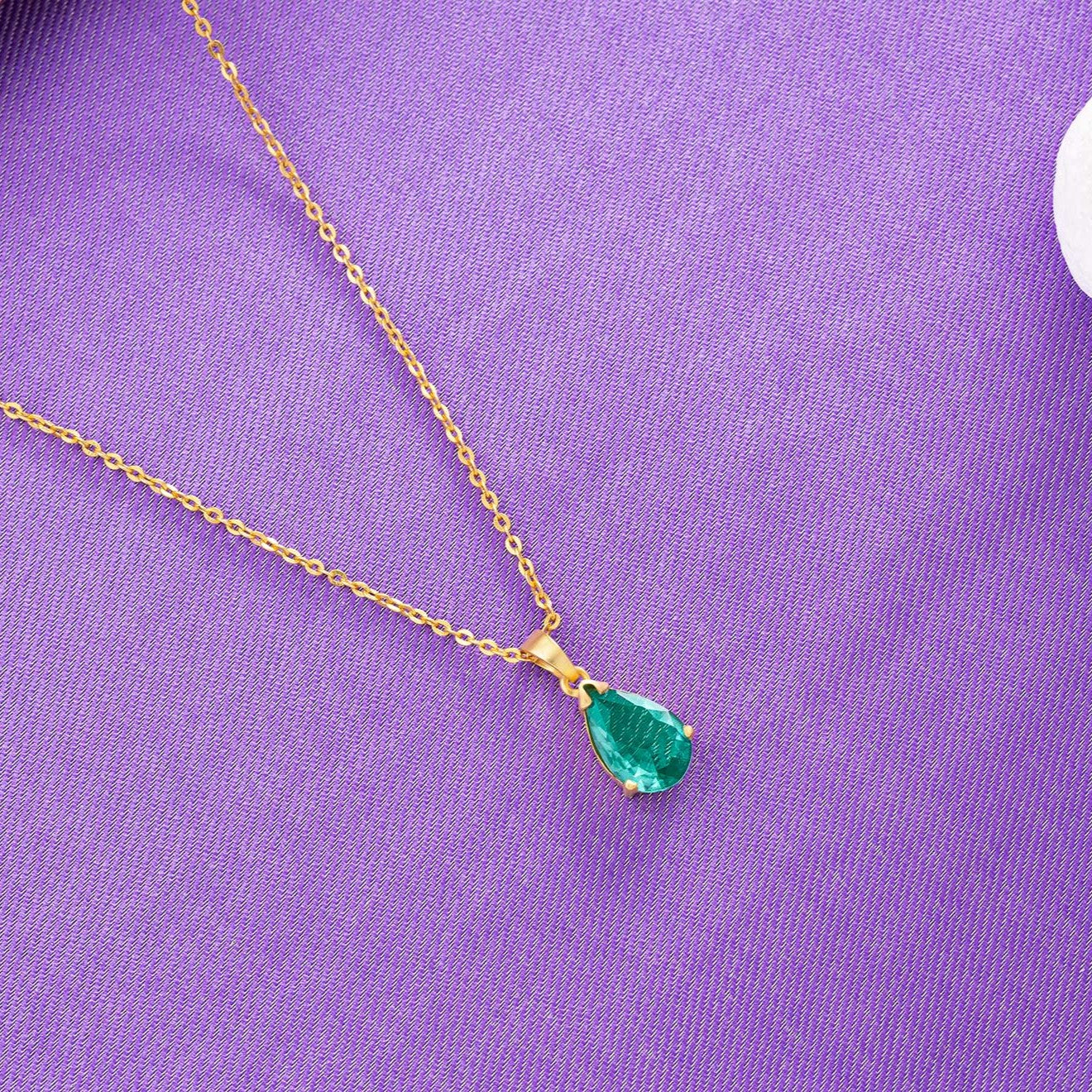 golden necklace with a small stone