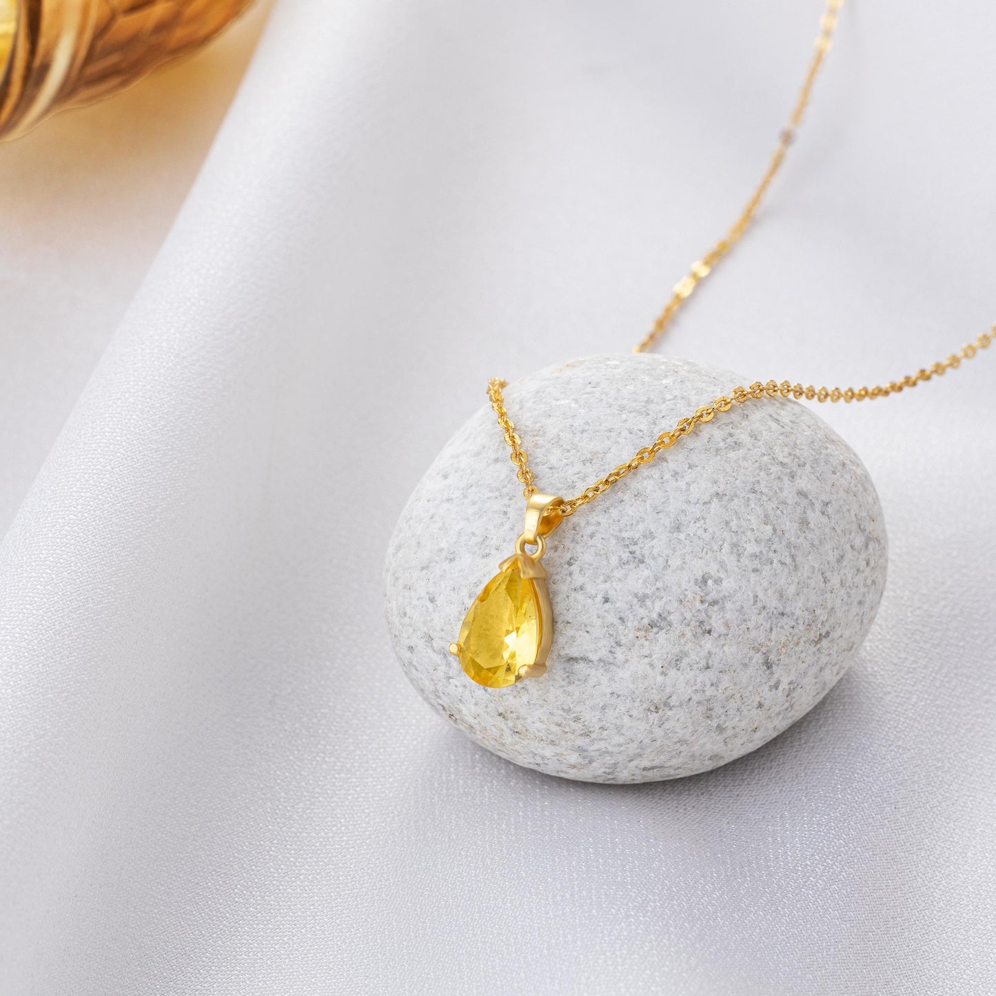 golden necklace with a small stone