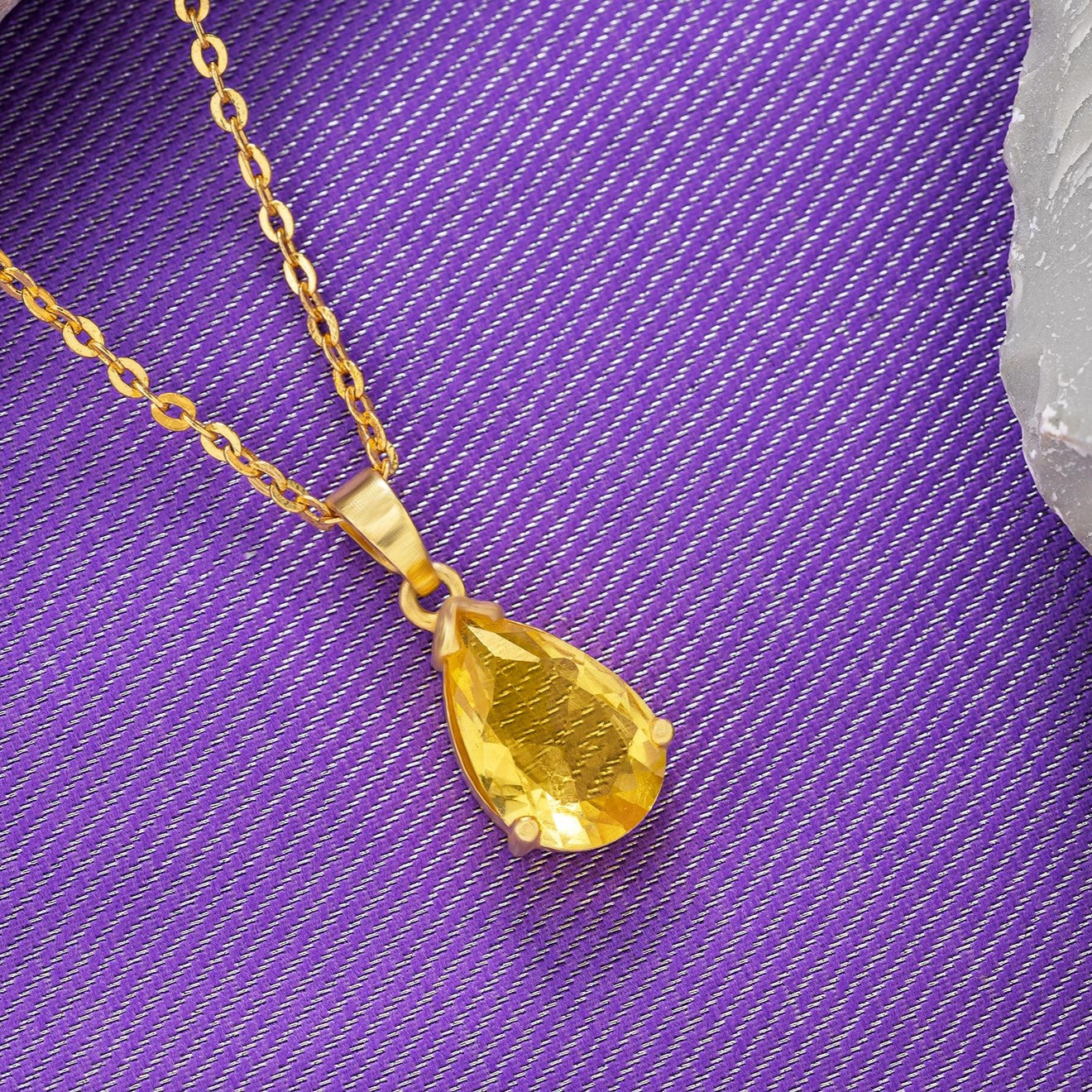 golden necklace with a small stone