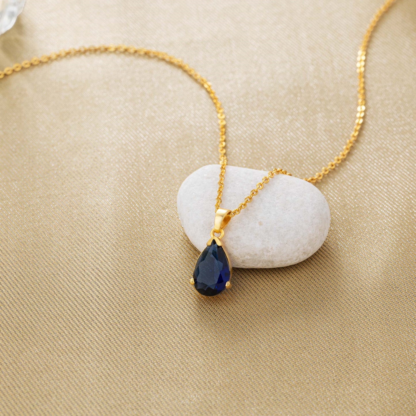 golden necklace with a small stone