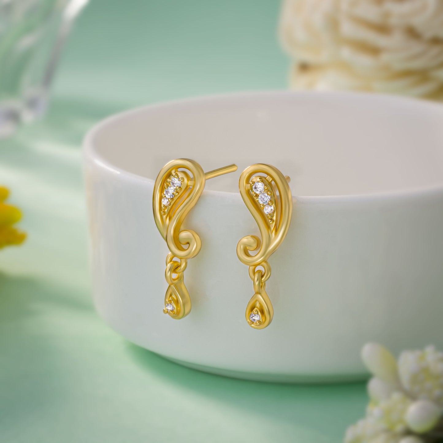 pair of golden earrings with diamonds