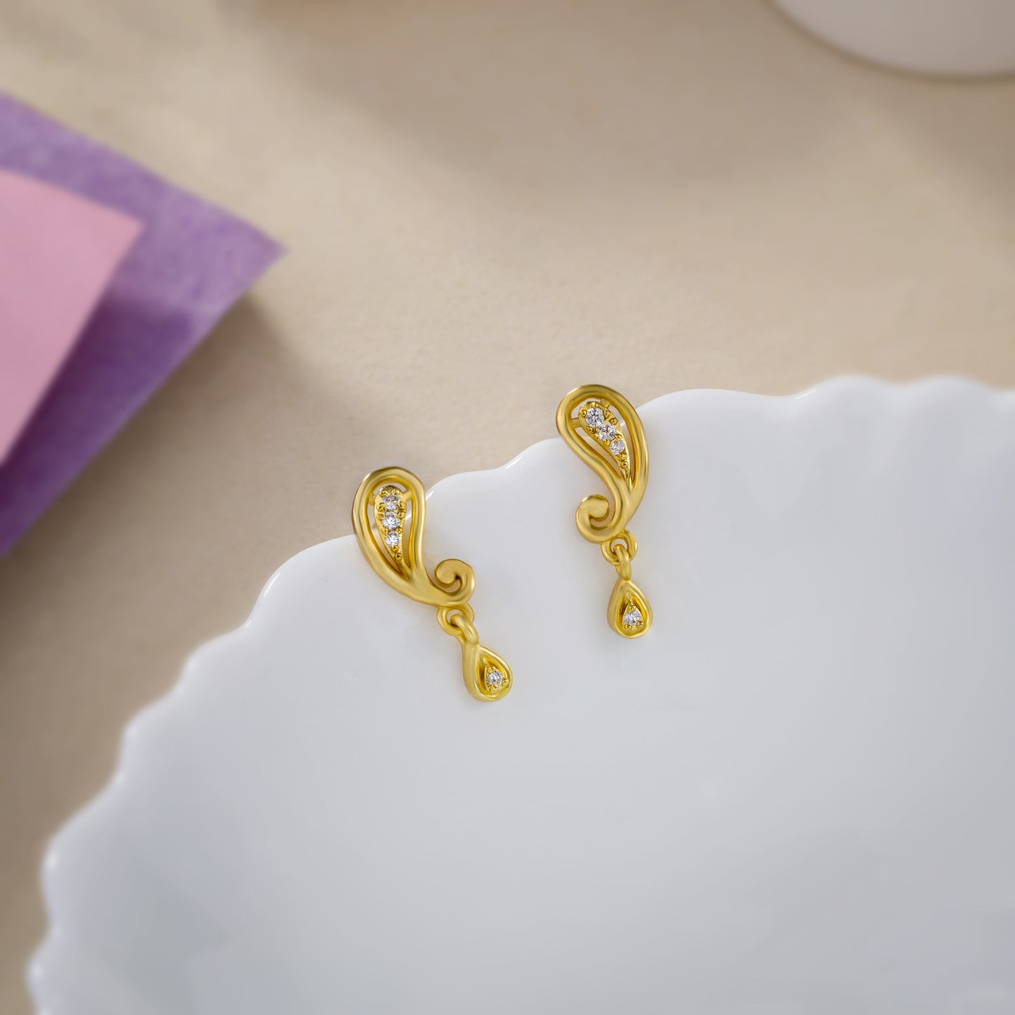 pair of golden earrings with diamonds