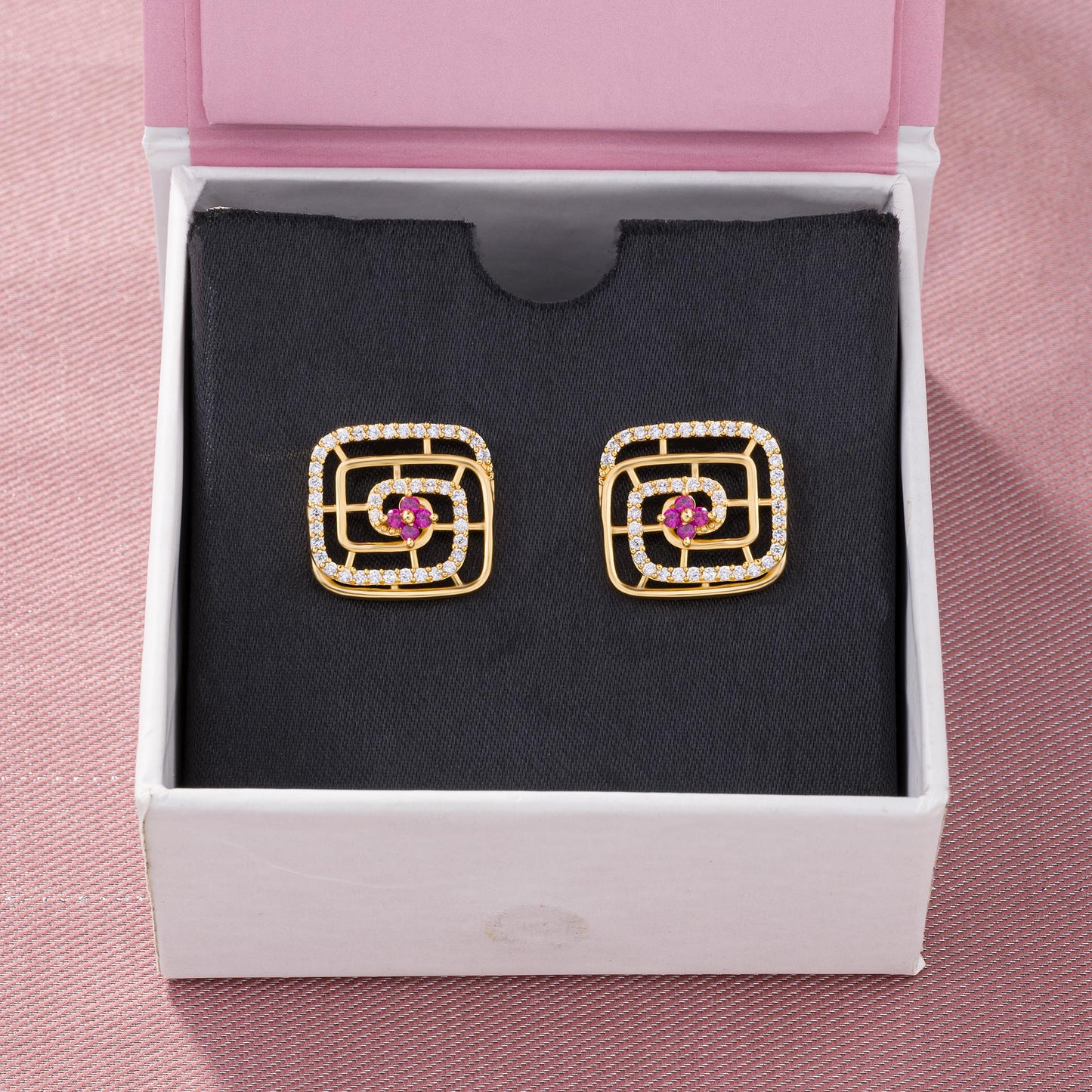 pair of golden earrings with ruby and diamonds