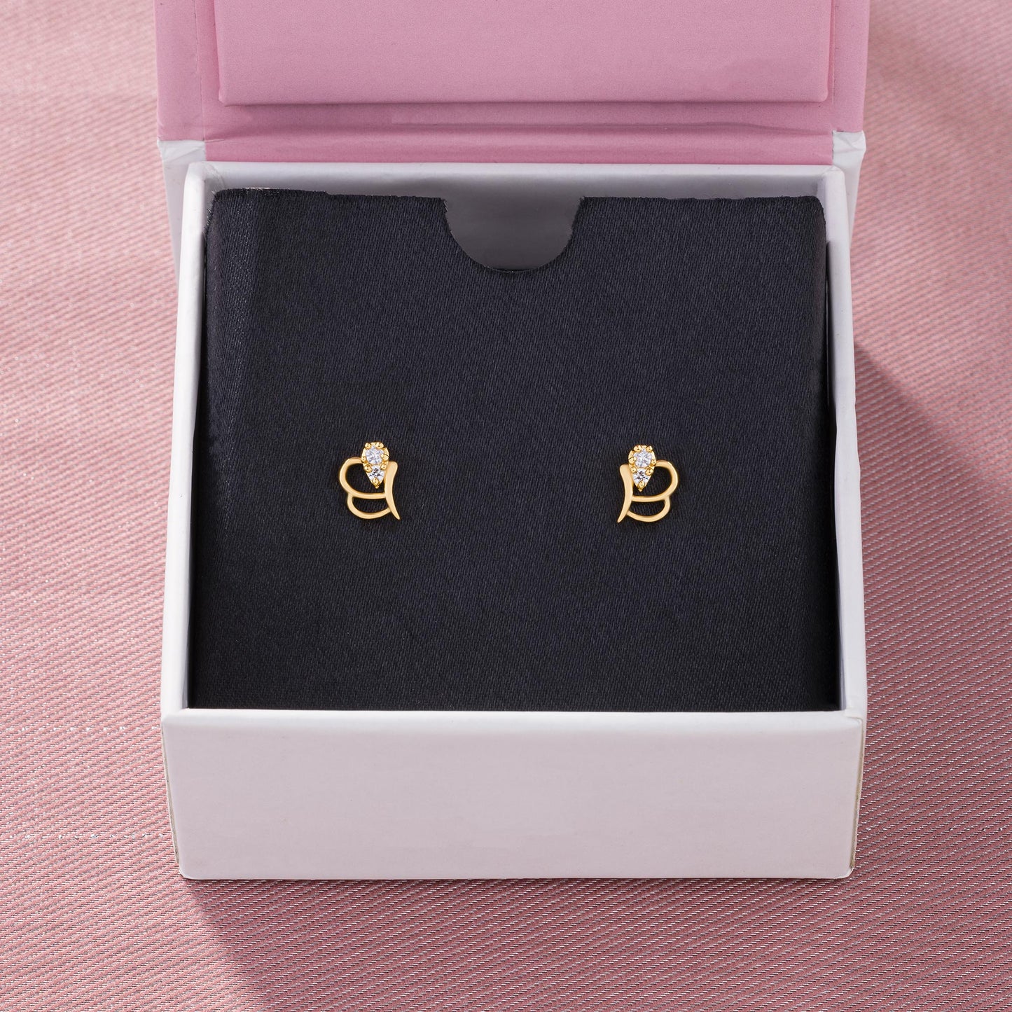 pair of golden earrings with a diamond