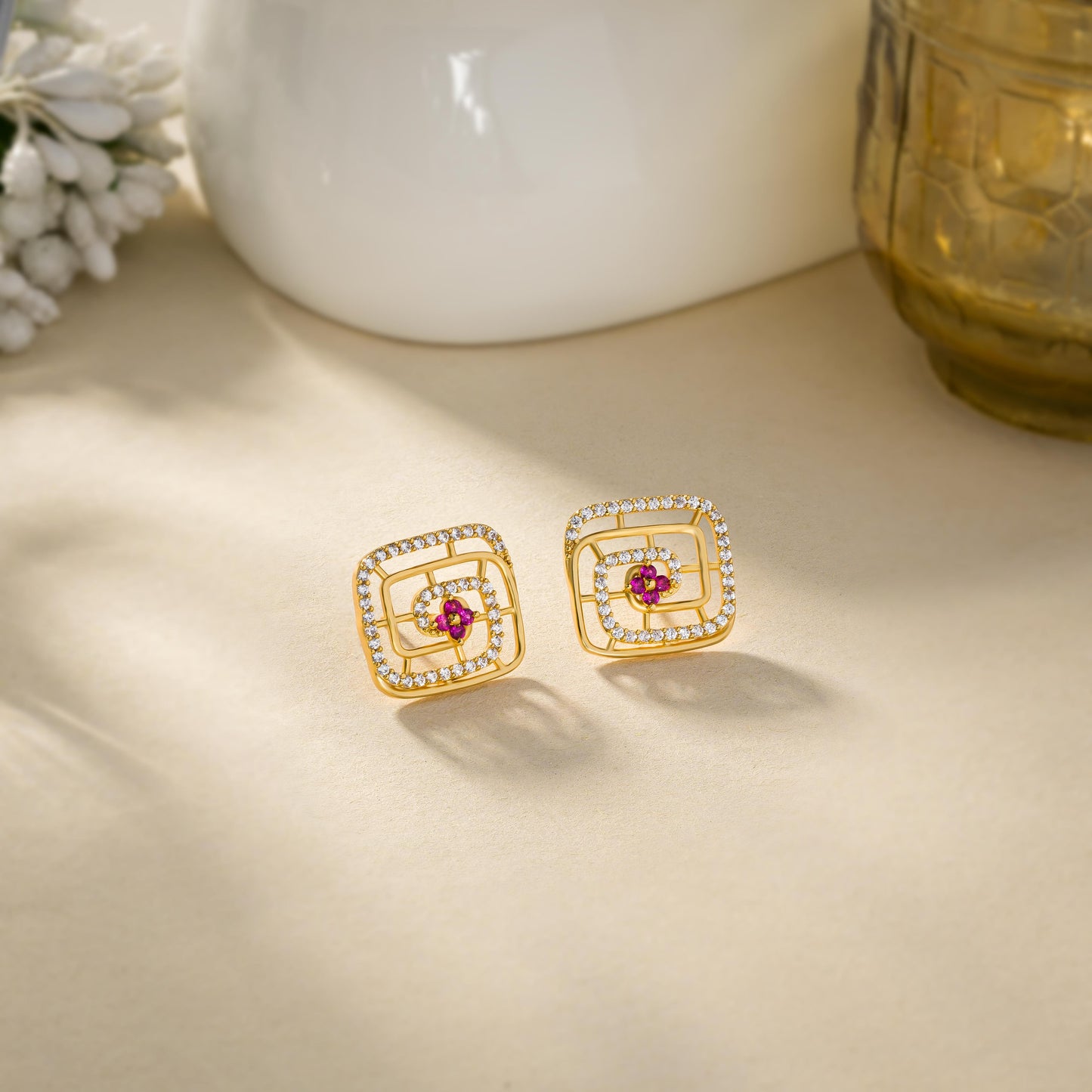 pair of golden earrings with ruby and diamonds