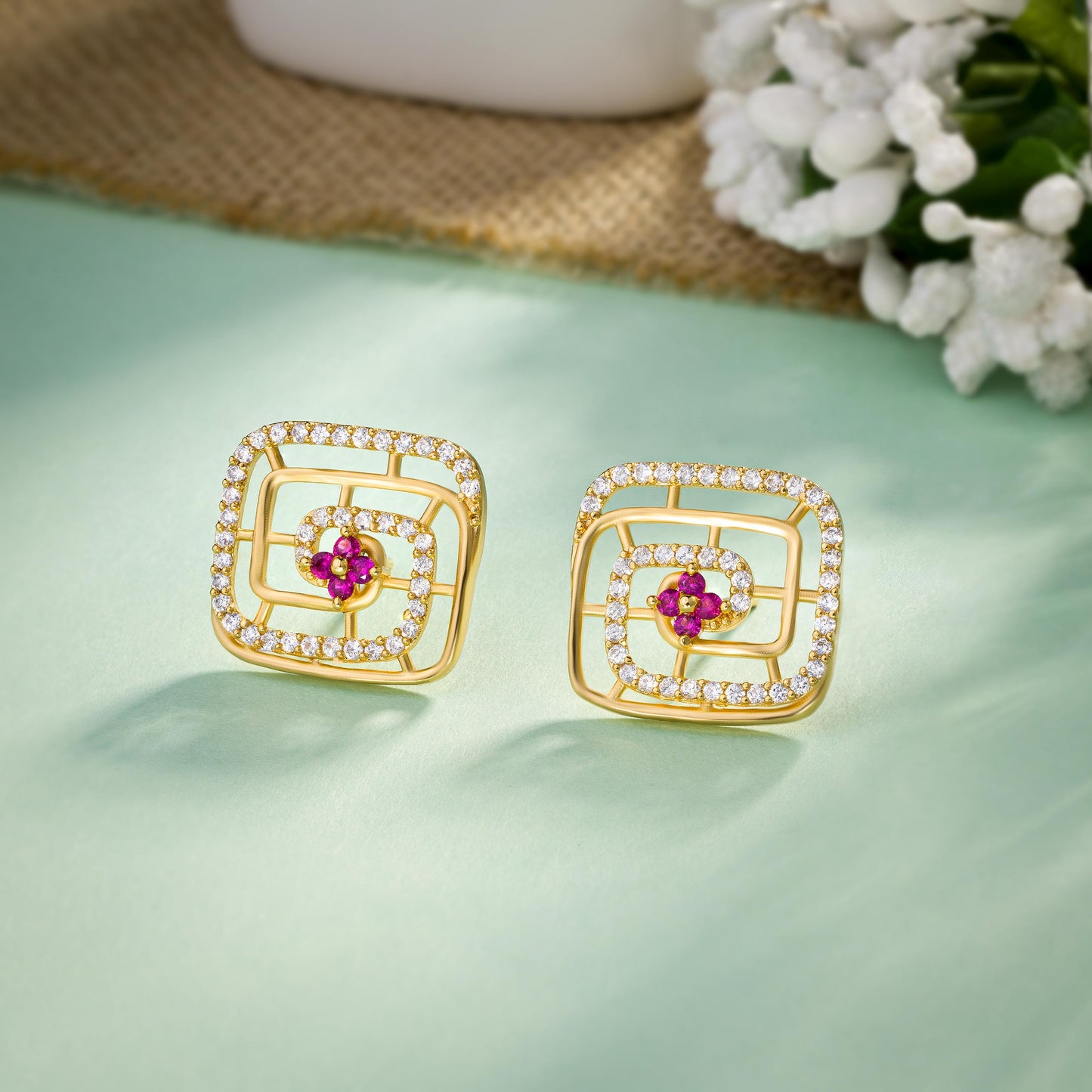 pair of golden earrings with ruby and diamonds