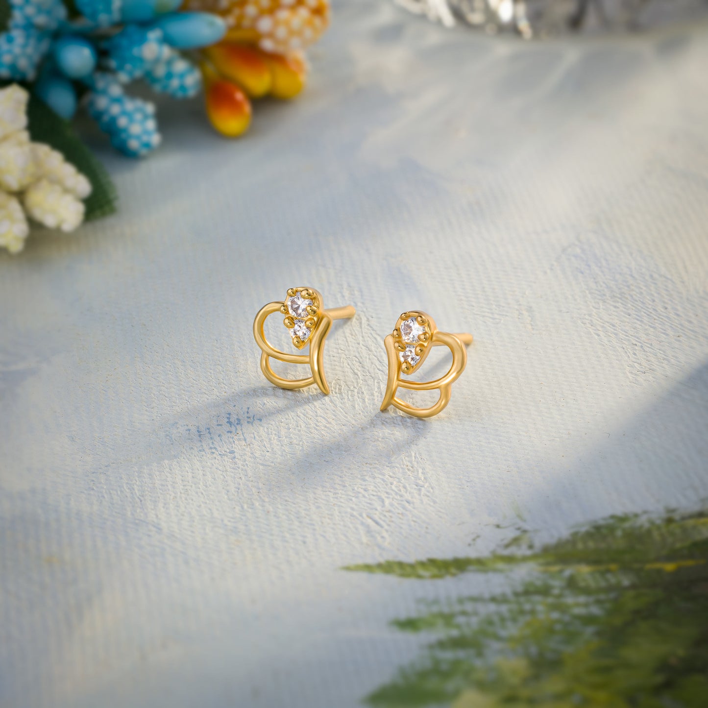 pair of golden earrings with a diamond