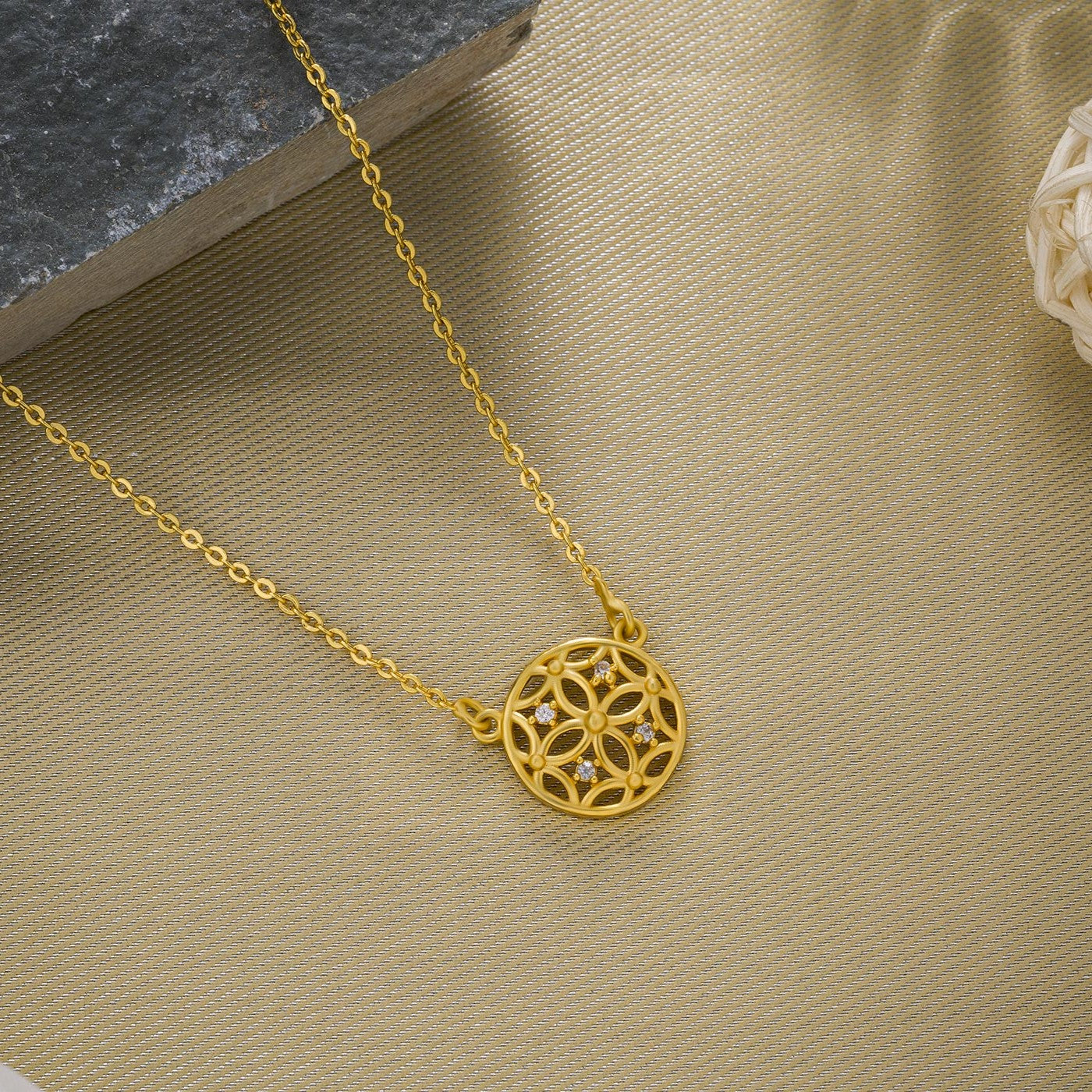 golden necklace with a small diamond on the front