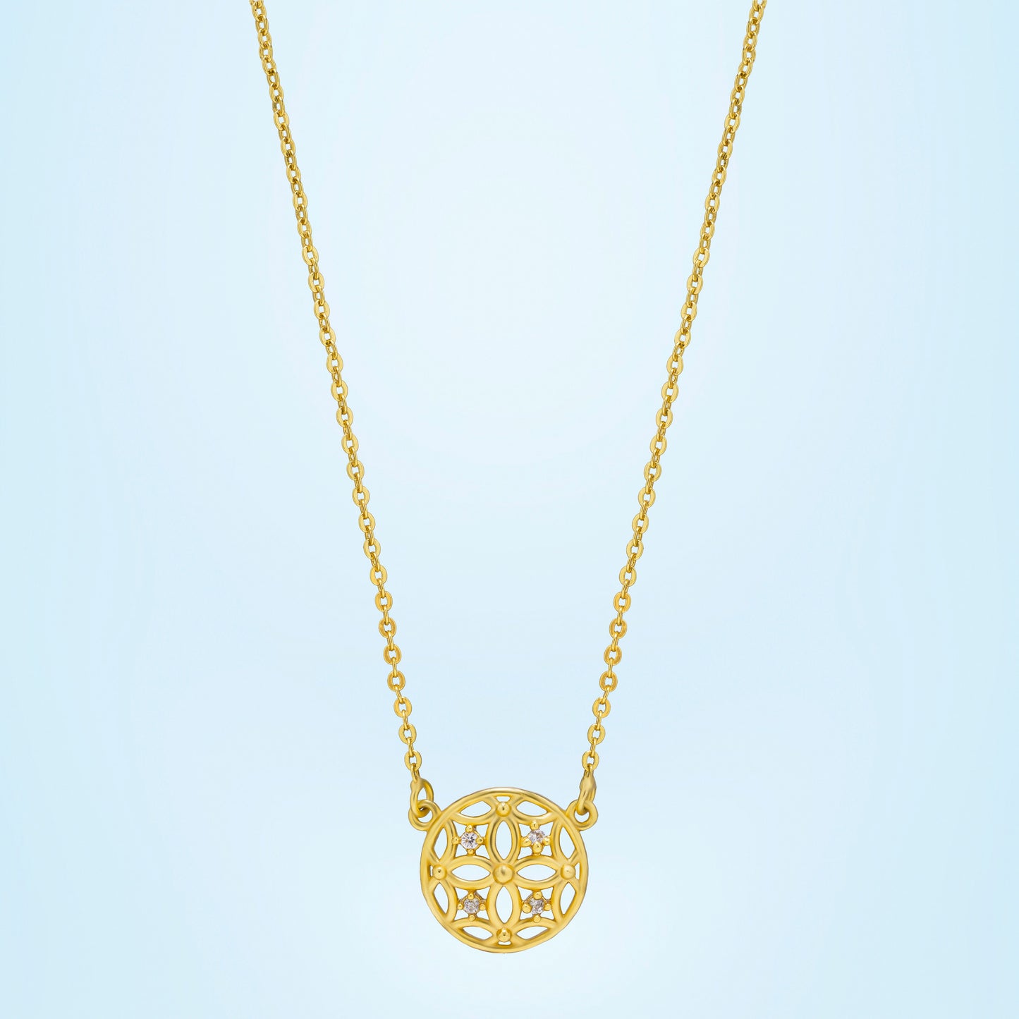 golden necklace with a small diamond on the front