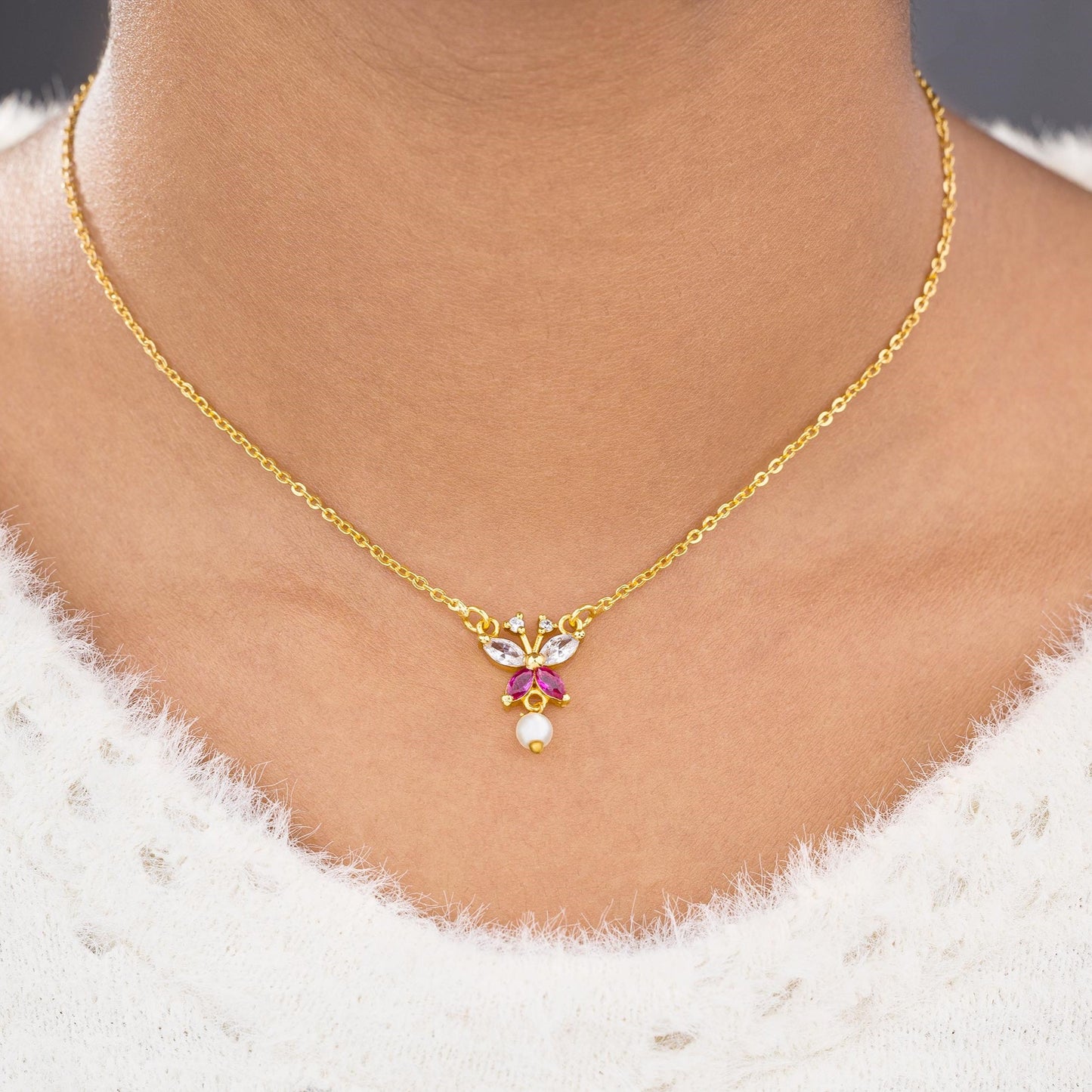 golden necklace with a butterfly pendant