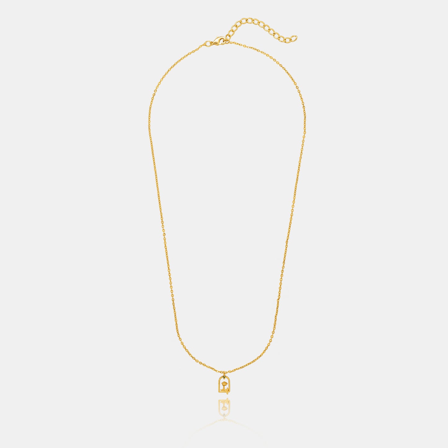 golden necklace with a small letter on it