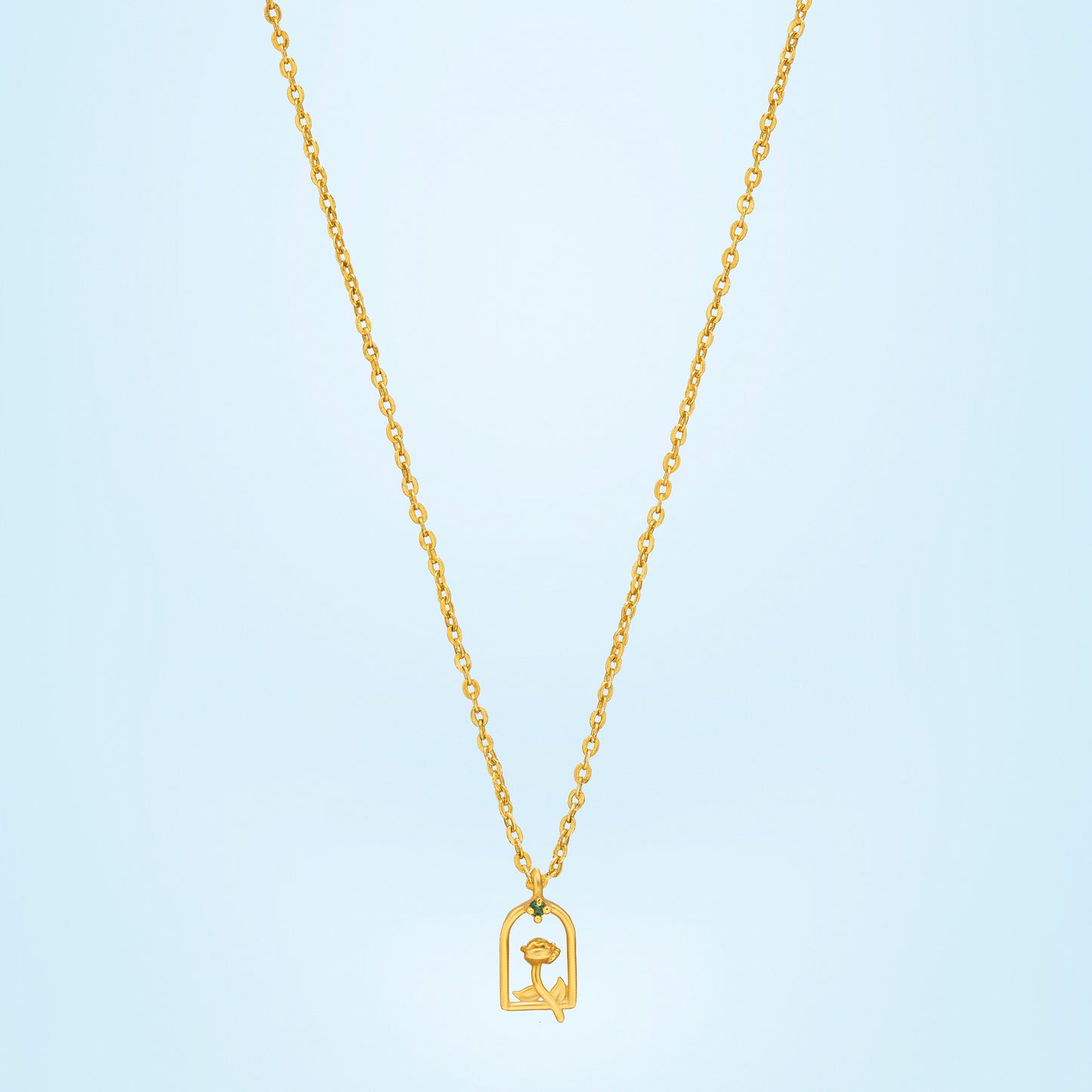 golden necklace with a small letter on it