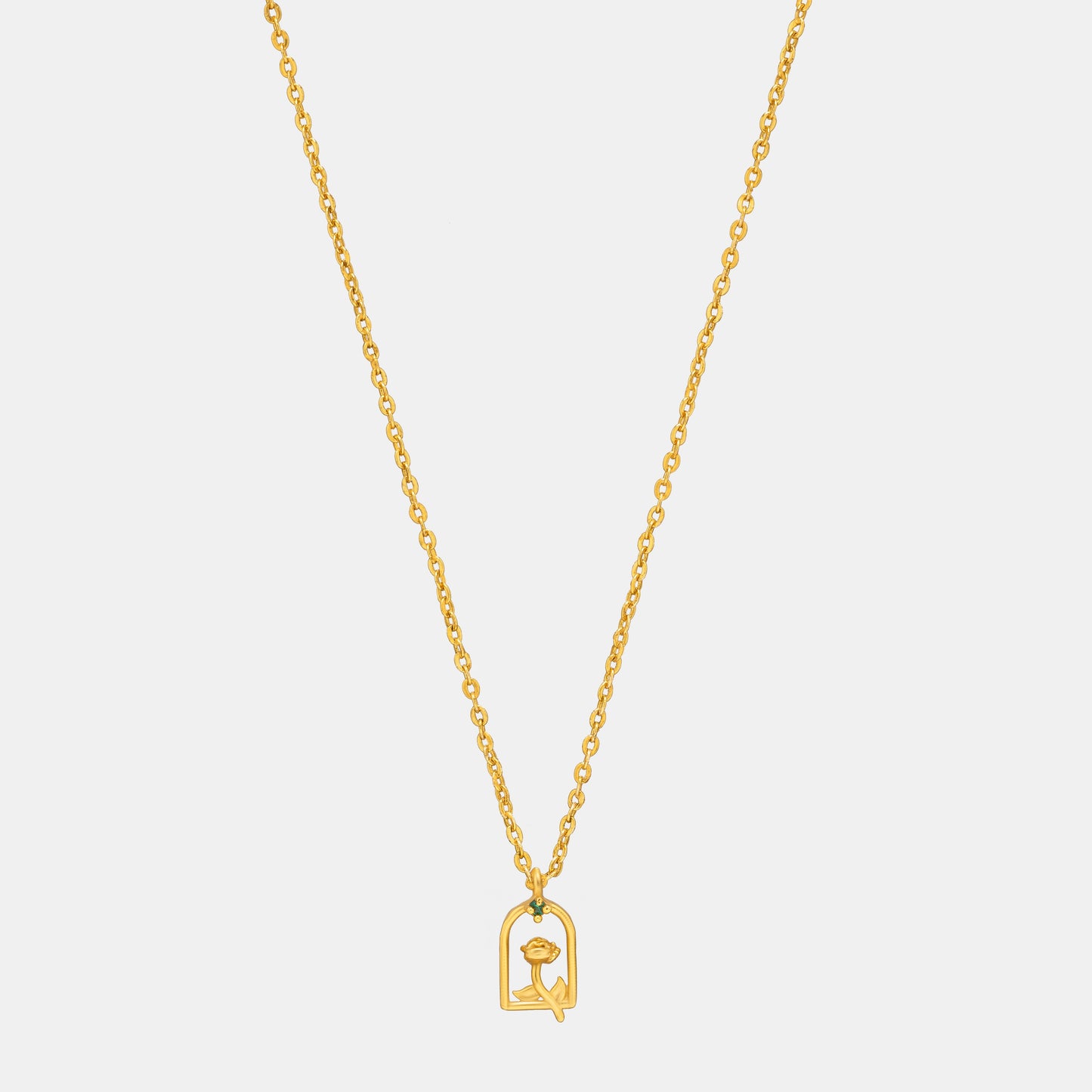 golden necklace with a small letter on it